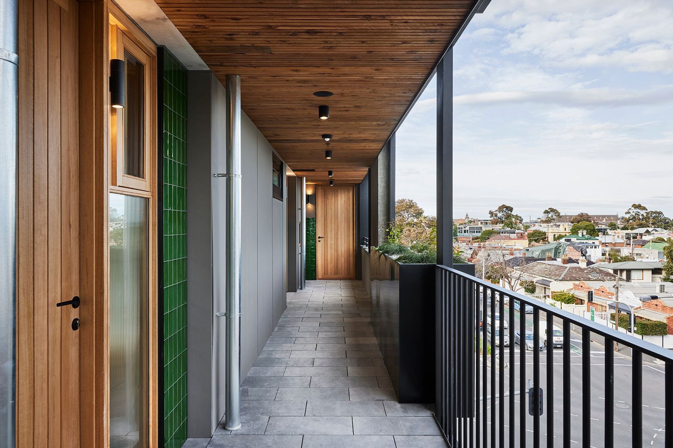 Timber doors add warmth to this apartment complex.