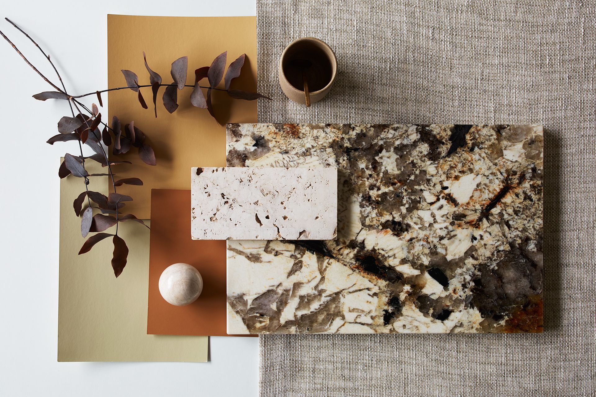 This materials board by James Dunlop Textiles includes the brand's organic, open weave Homespun textile – paired with warm tones and stone textures.