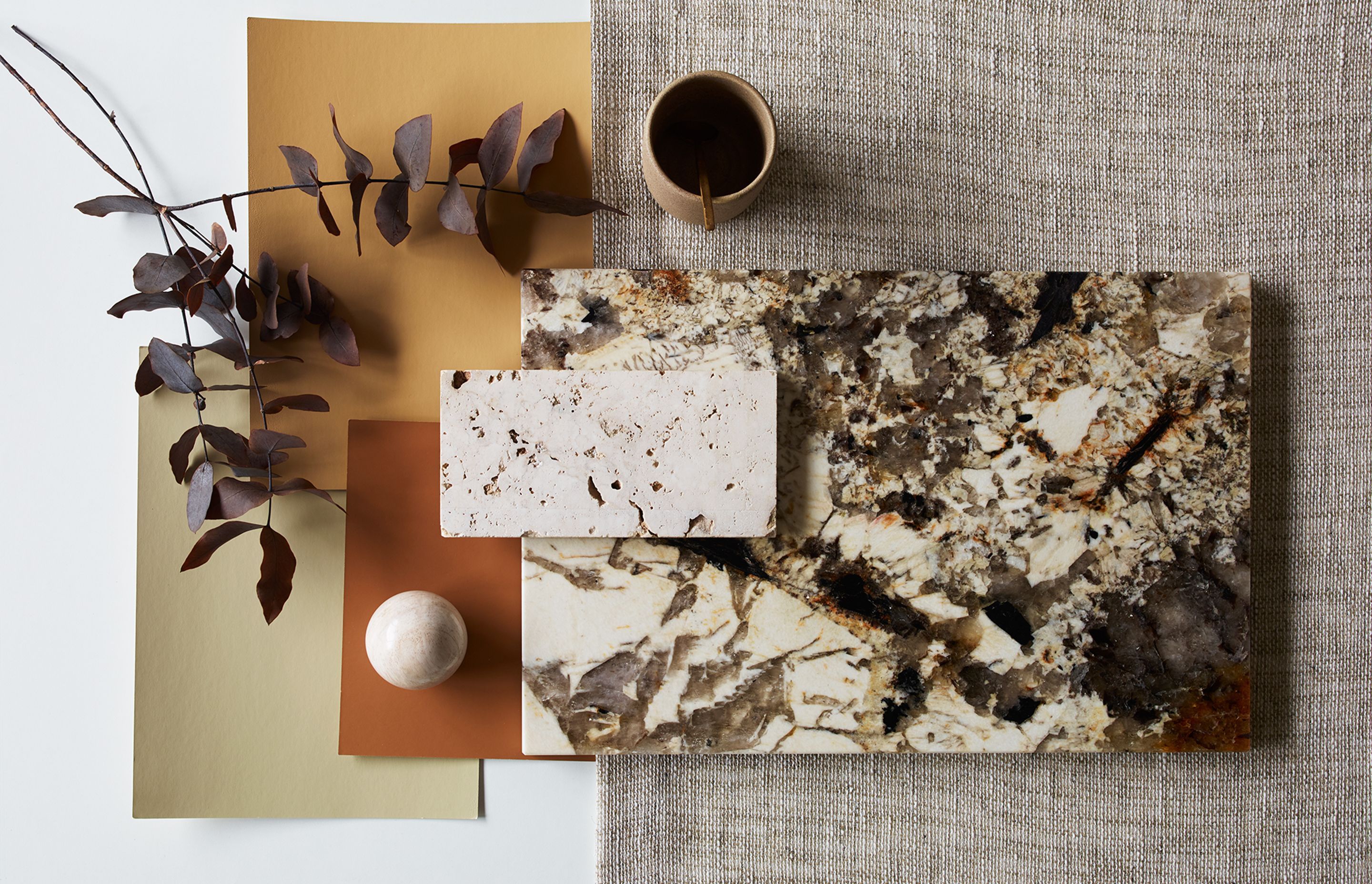 This materials board by James Dunlop Textiles includes the brand's organic, open weave Homespun textile – paired with warm tones and stone textures.