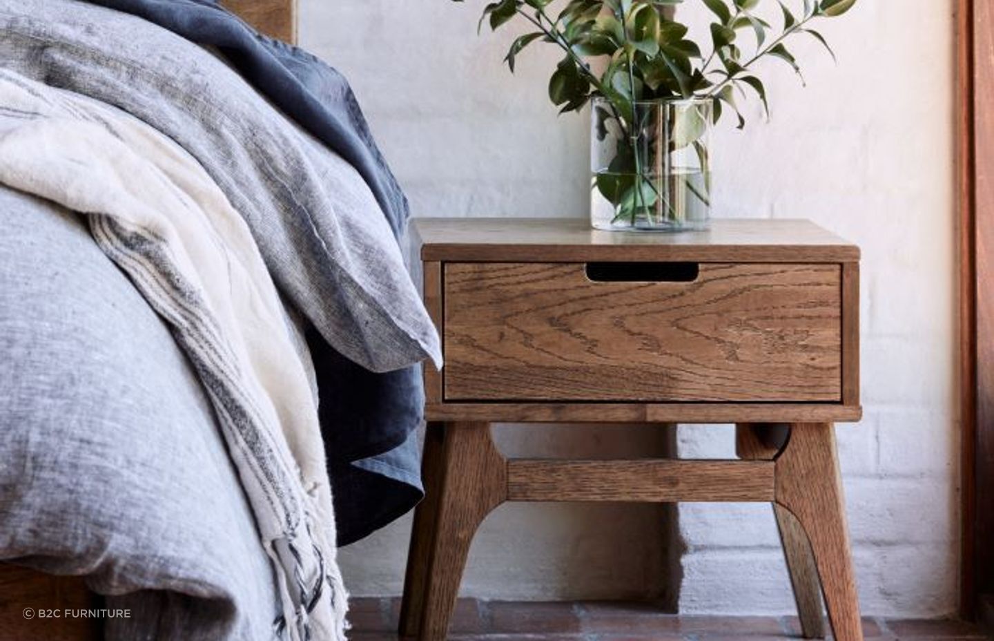 This Paris Hardwood Bedside Table is contemporary yet compact, fitting well in tight spaces.