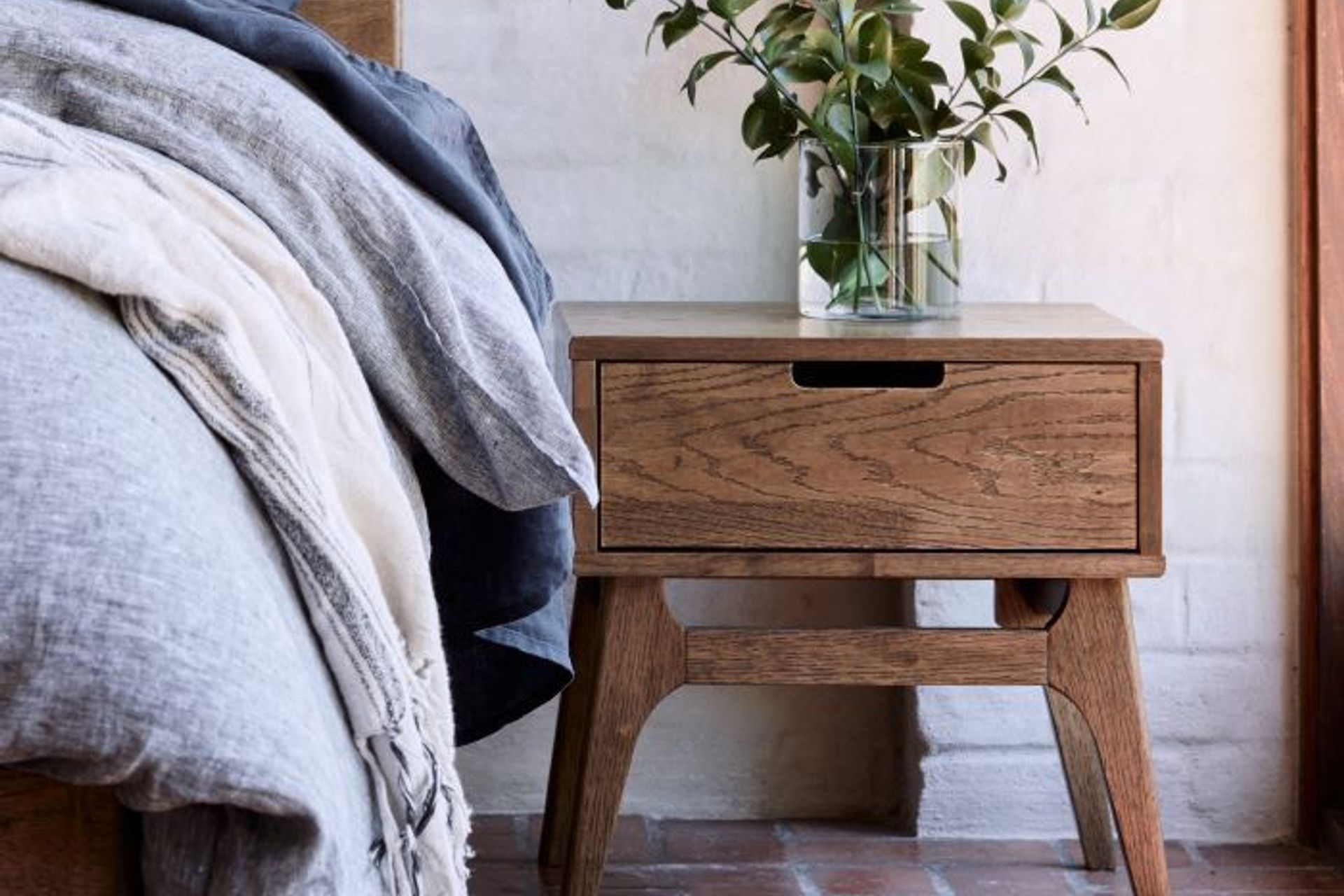 This Paris Hardwood Bedside Table is contemporary yet compact, fitting well in tight spaces.