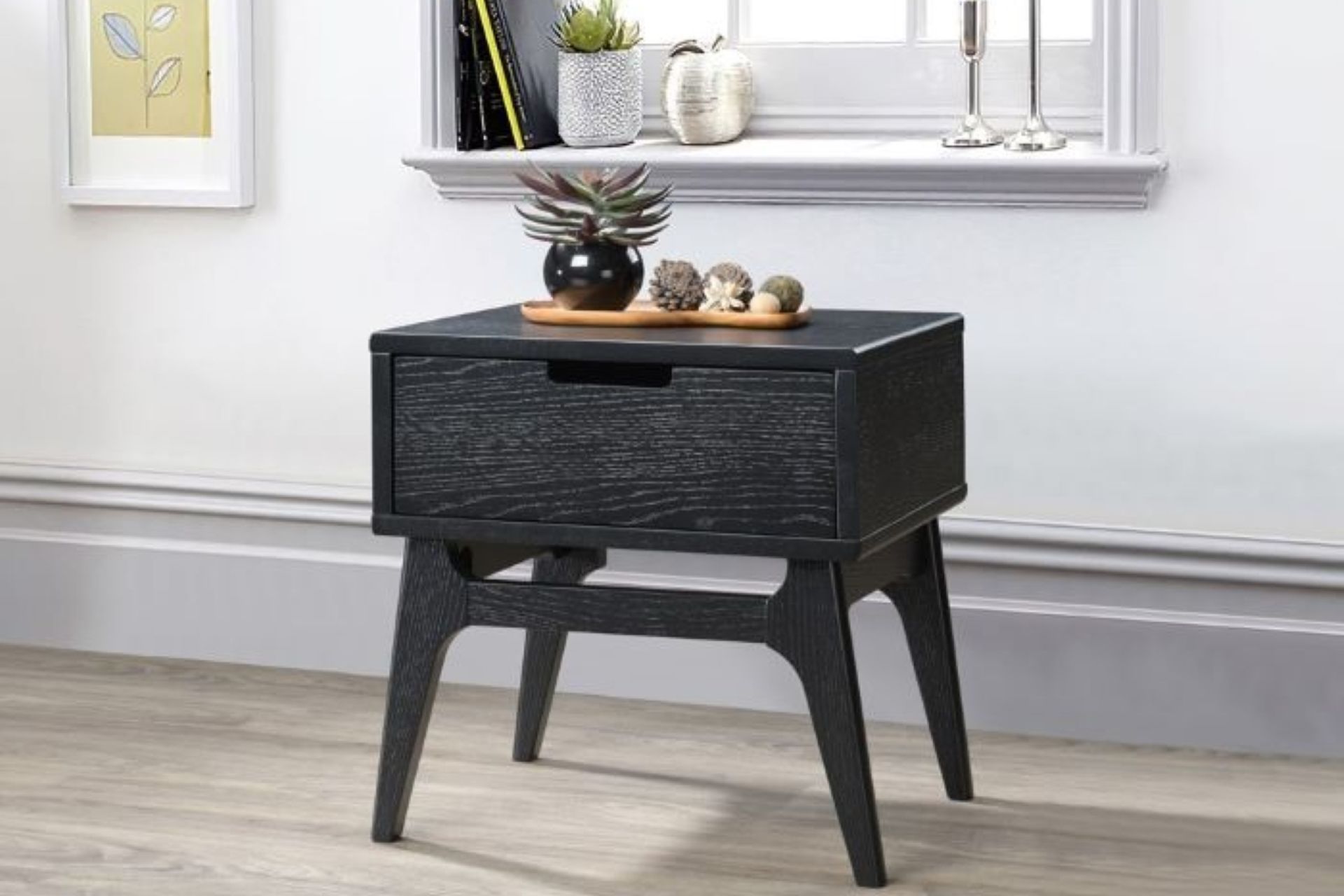 Hardwood side tables, such as this Paris Hardwood Bedside Table, are popular due to their durability and sturdiness.