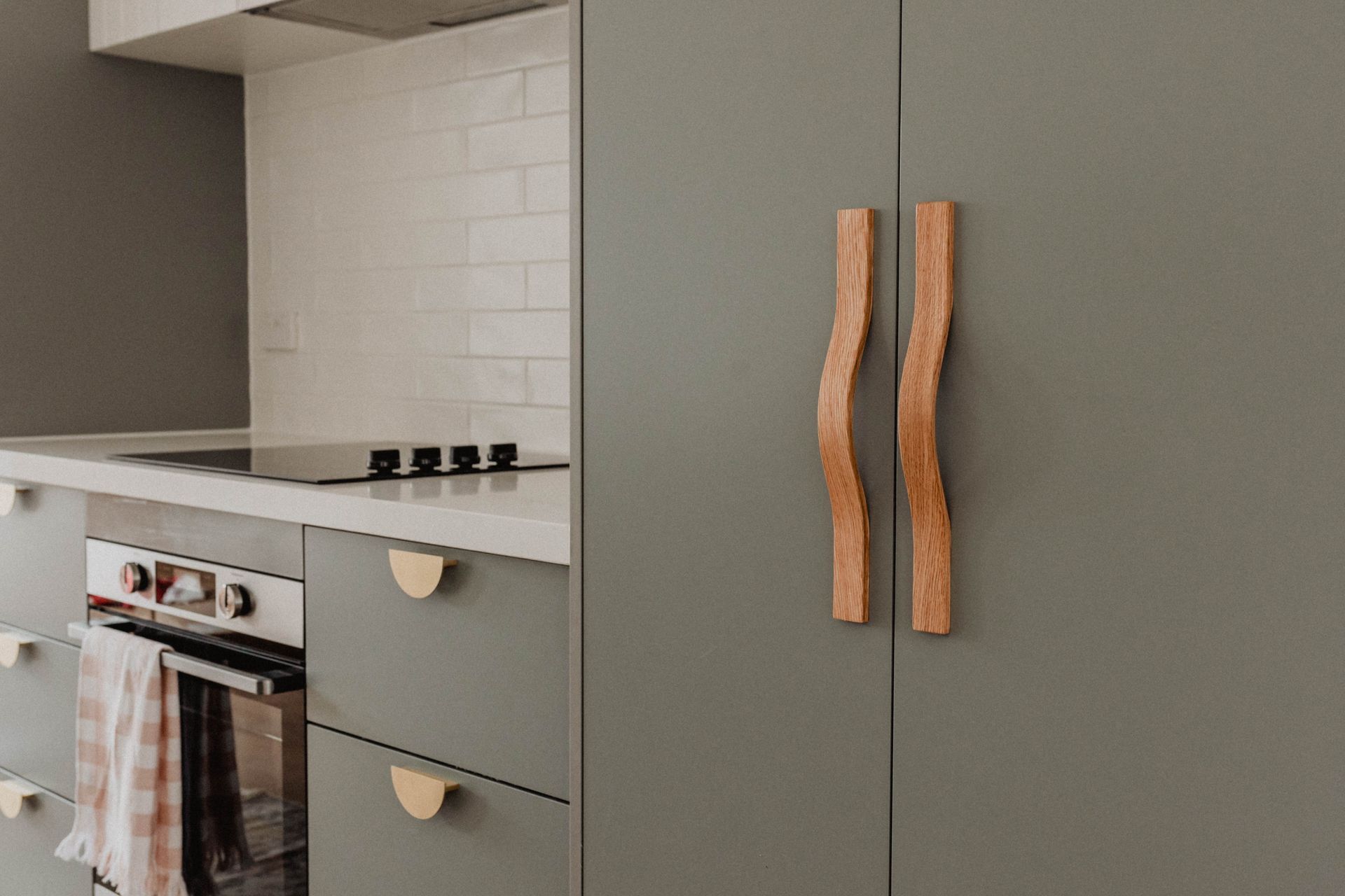 A close-up of the Chicama Wave timber handles; available in walnut stained American oak, clear-coated American oak, ebony-stained American oak, and raw American oak.