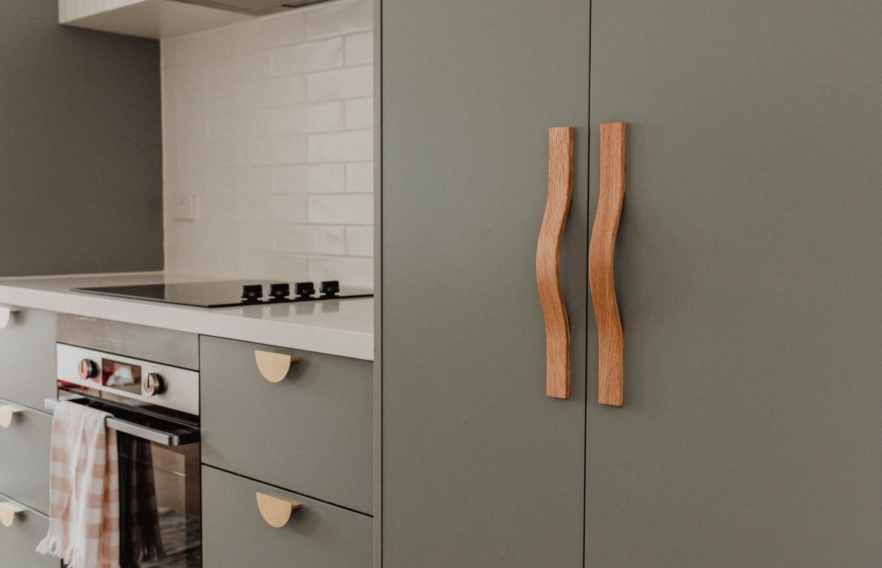 A close-up of the Chicama Wave timber handles; available in walnut stained American oak, clear-coated American oak, ebony-stained American oak, and raw American oak.