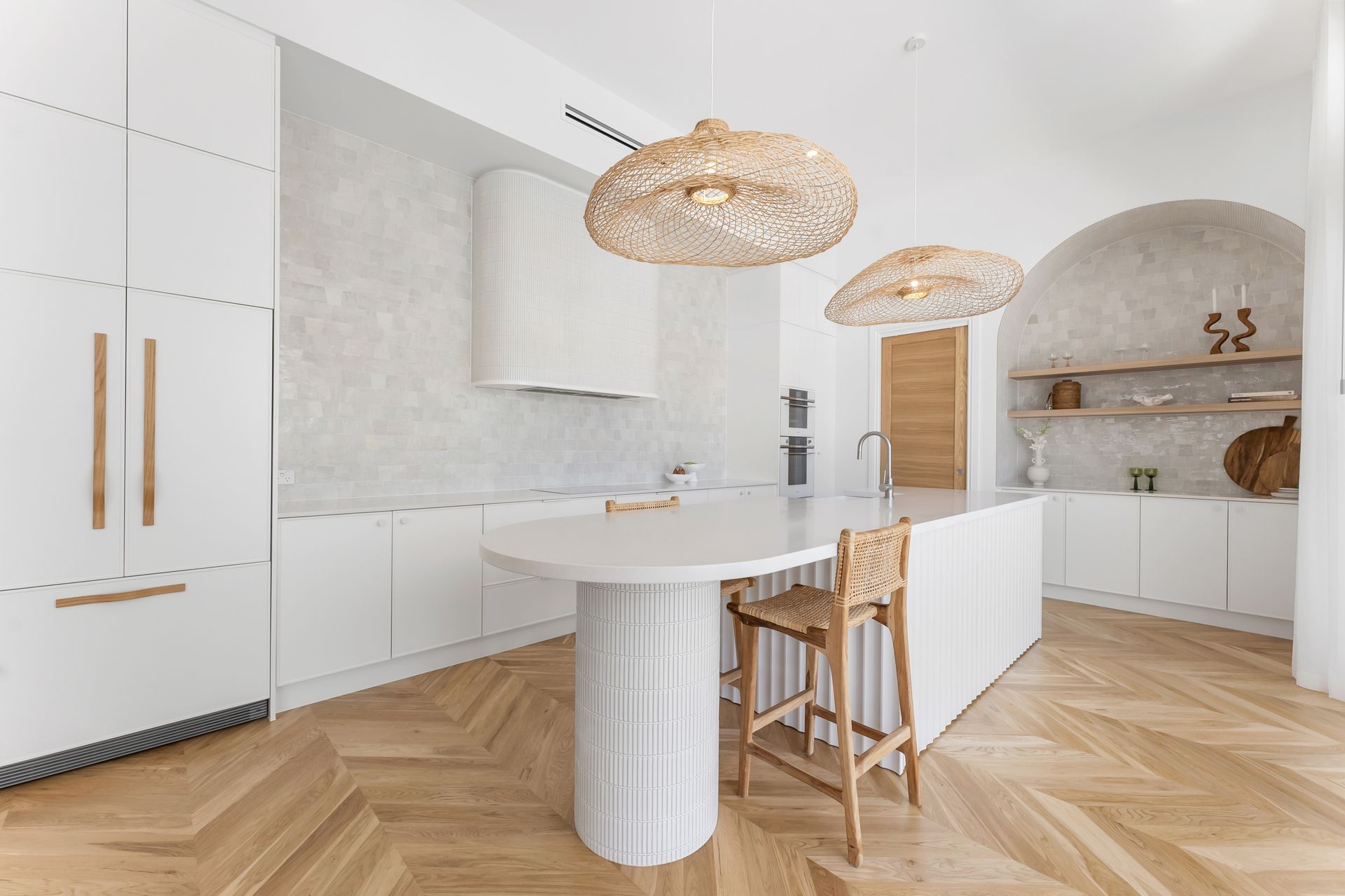 In this serene contemporary kitchen, the Chicama Wave timber cupboard handles offer a fun and modern element.