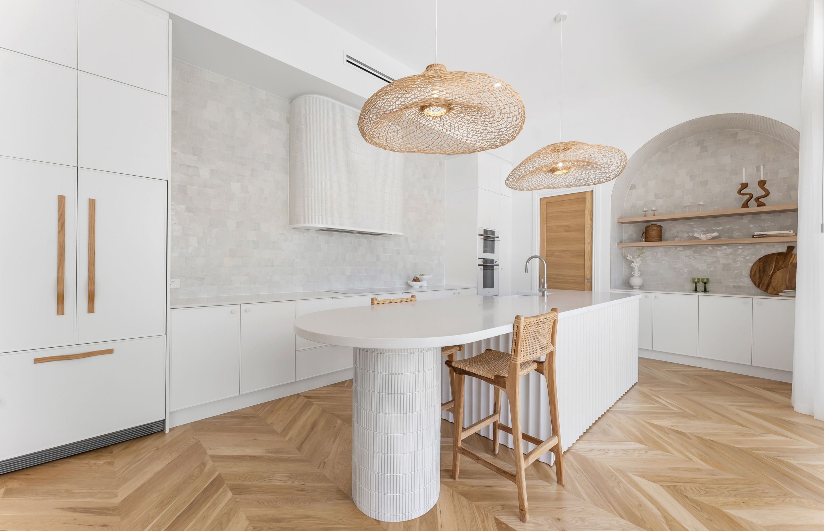 In this serene contemporary kitchen, the Chicama Wave timber cupboard handles offer a fun and modern element.