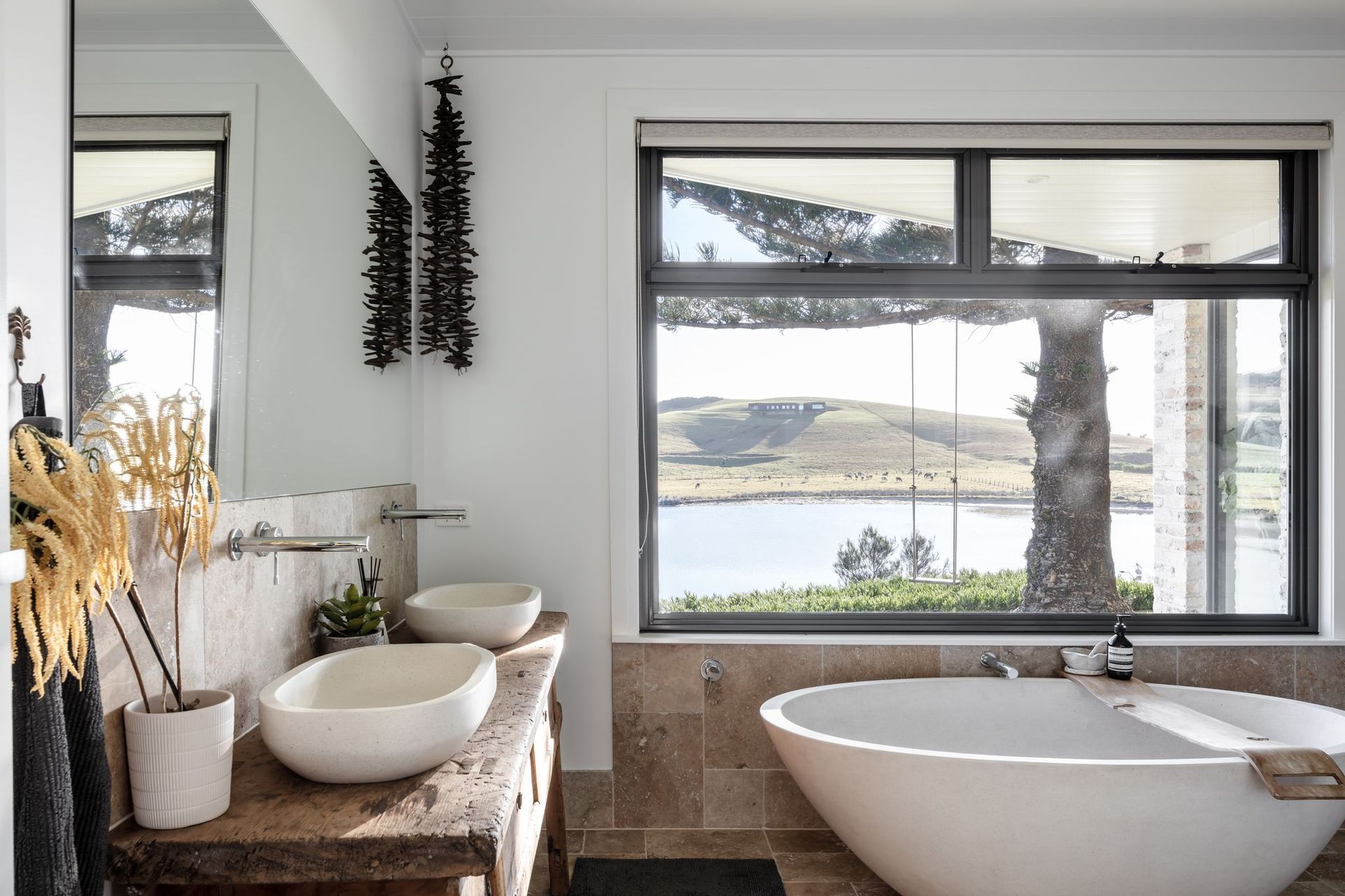 This beautiful bathroom in Werri Beach does a fine job of showcasing natural materials