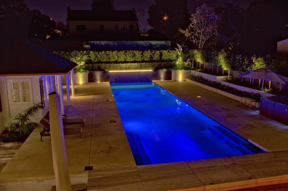 Coloured lighting can make a pool glow with stylish energy.