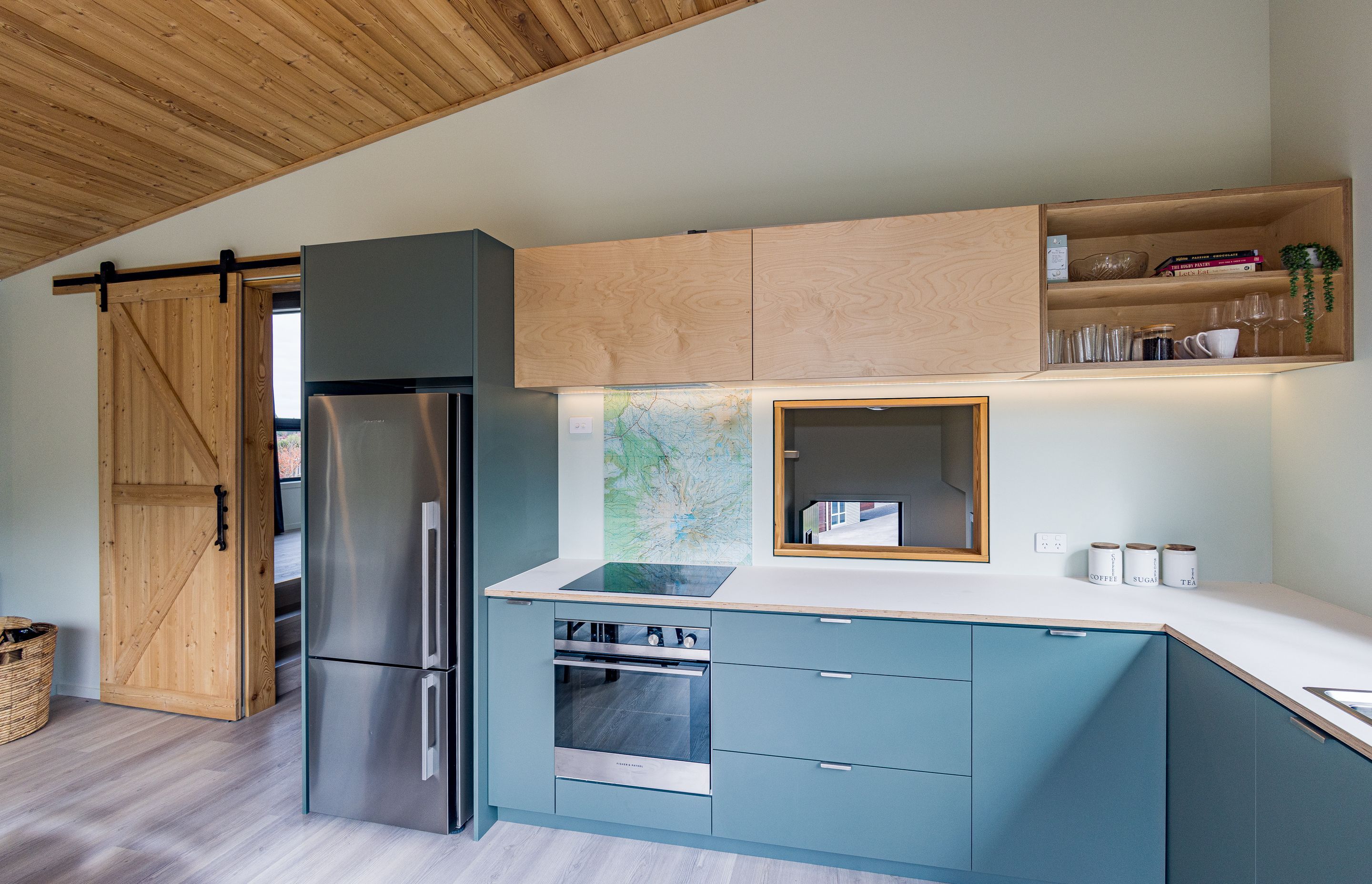 Timber is used throughout as a feature – here, cabinetry, ceiling and barn door.