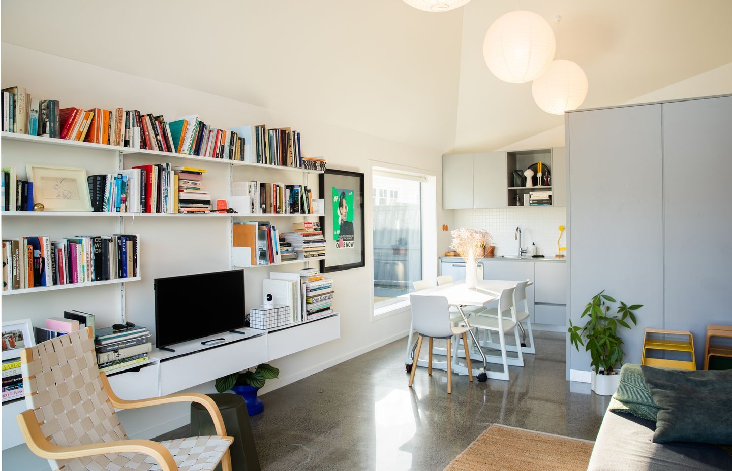 The white walls are the perfect backdrop for the homeowner's collection of art and books.