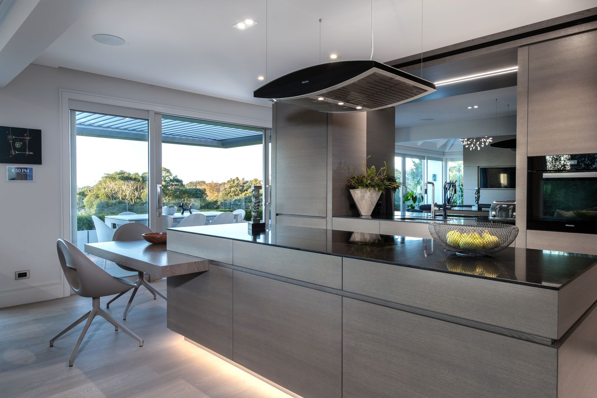 Constructed from stained American white oak veneer and finished with a clear, two-pack polyurethane, this kitchen is an example of the precision work carried out by DBJ.