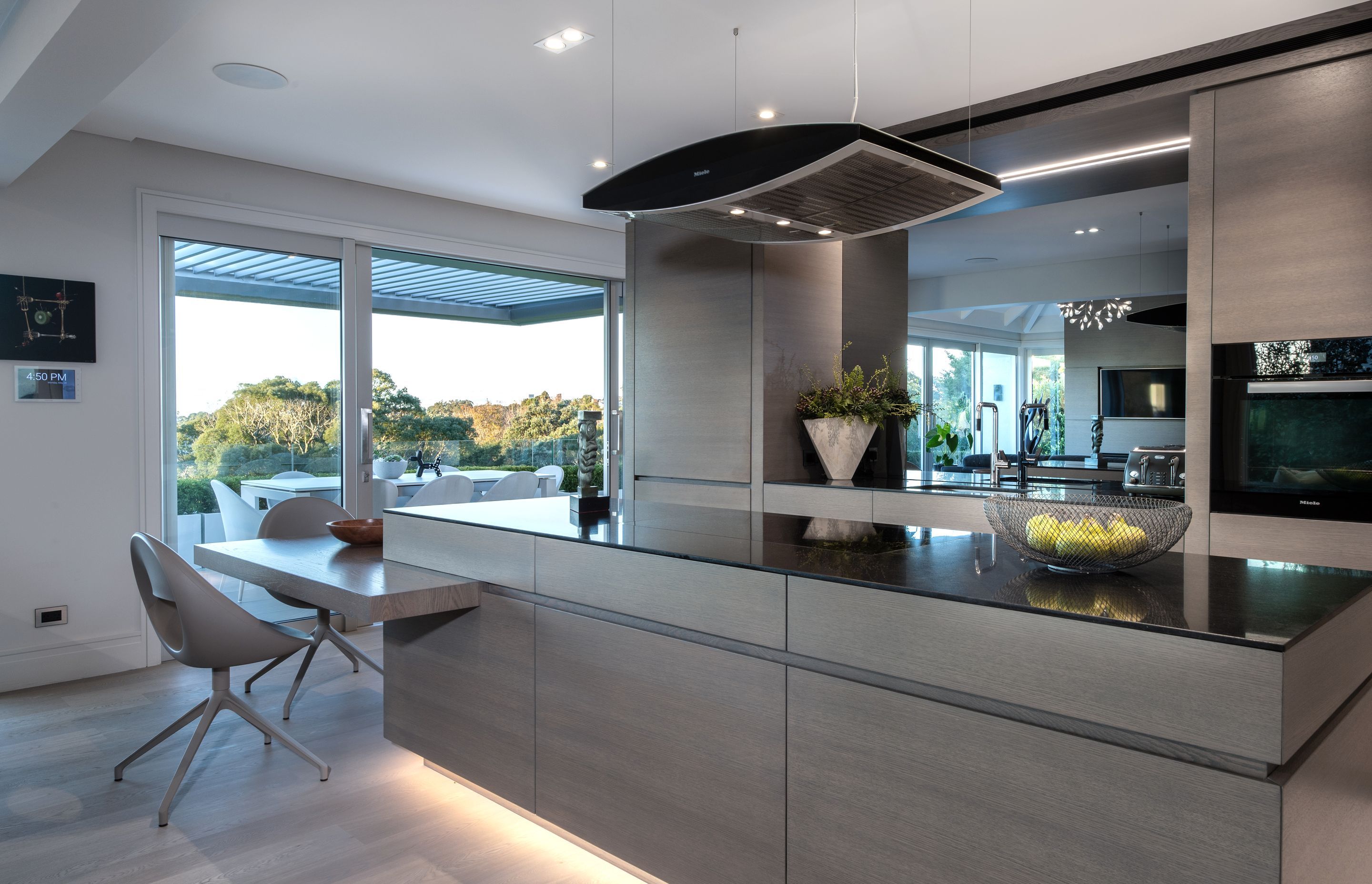 Constructed from stained American white oak veneer and finished with a clear, two-pack polyurethane, this kitchen is an example of the precision work carried out by DBJ.