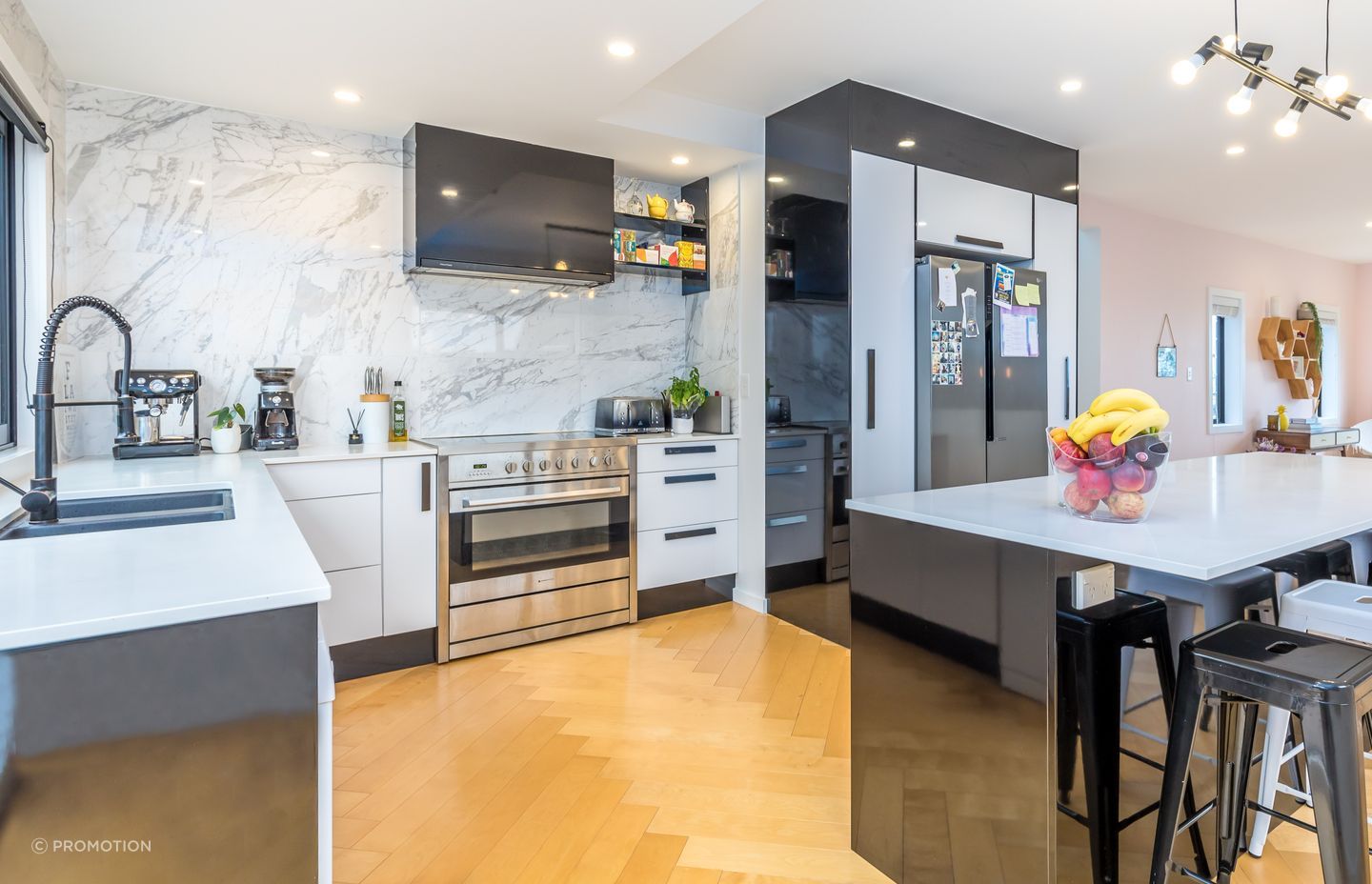 Installing the herringbone flooring was very time-consuming. Gloss tiles were taken full height in the kitchen for impact.