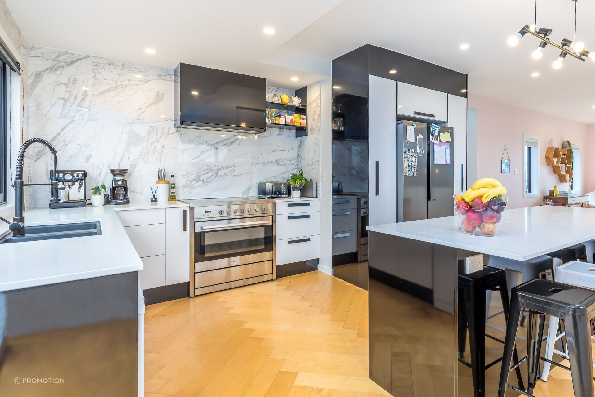 Installing the herringbone flooring was very time-consuming. Gloss tiles were taken full height in the kitchen for impact.