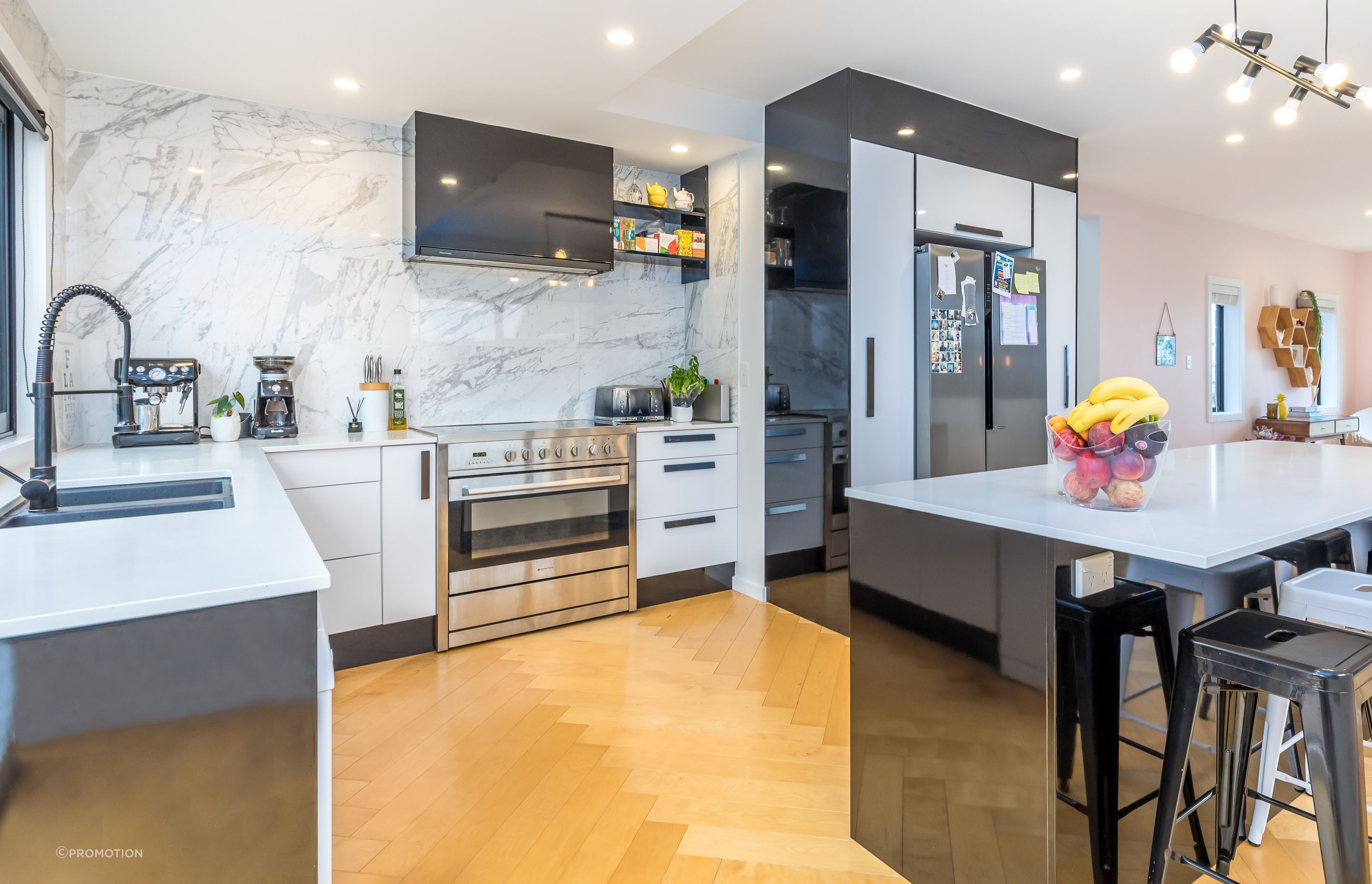 Installing the herringbone flooring was very time-consuming. Gloss tiles were taken full height in the kitchen for impact.