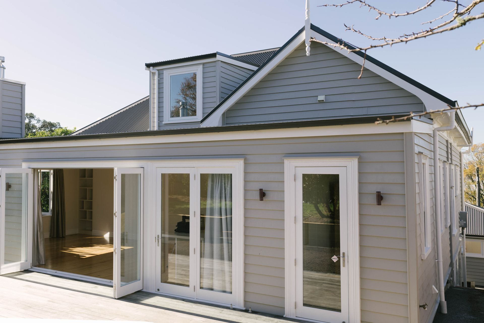 Walls were moved internally to create more space, and a new deck was added to extend the upstairs living area.