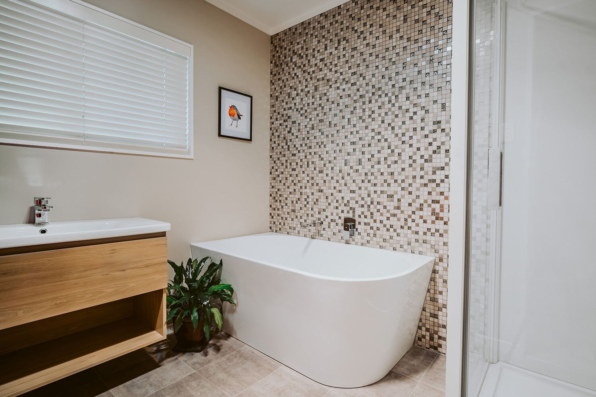 A nice mosaic accent wall makes the perfect option for a bathtub surround in Fitzherbert Avenue.