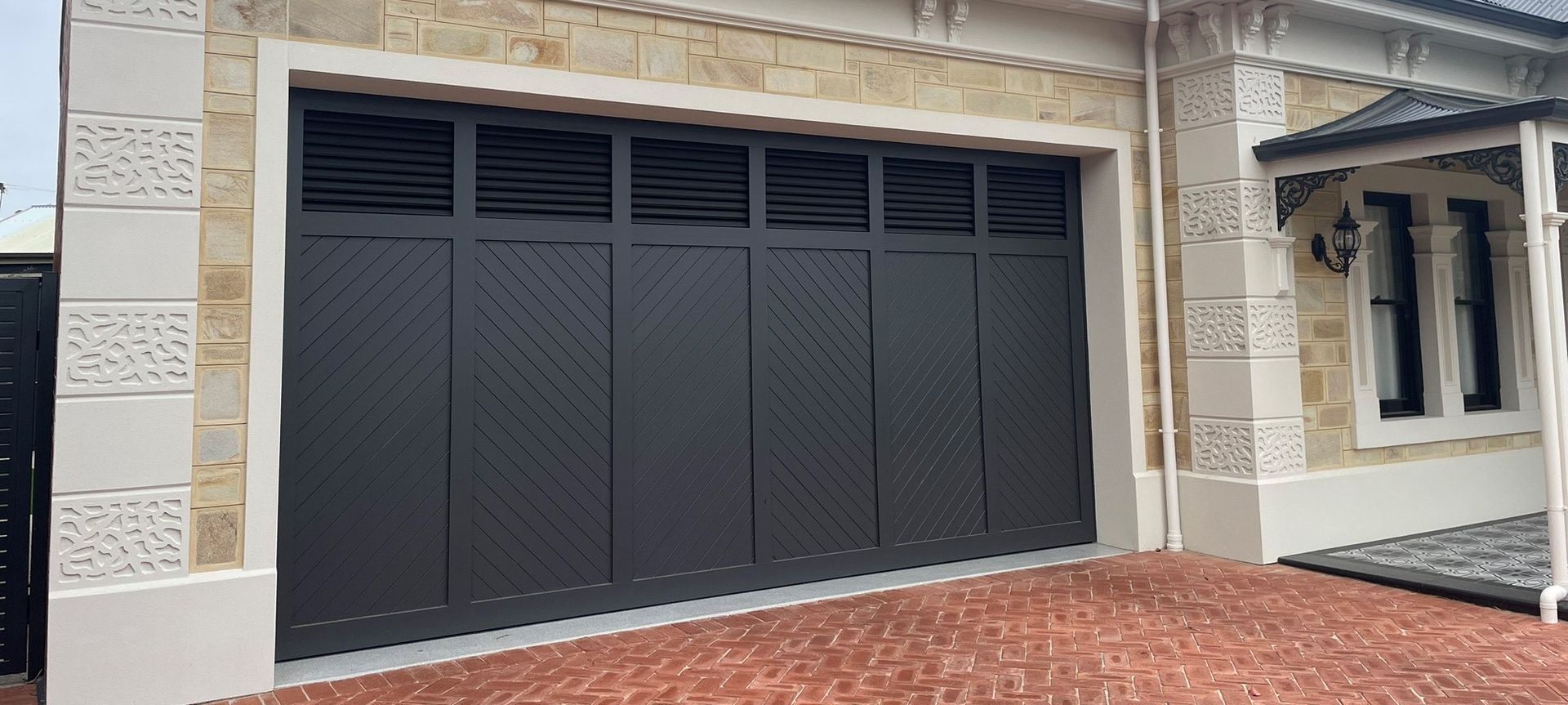 Western Red Cedar Tilt Door painted in Monument Matt featuring Louvred Windows | Steel-Line