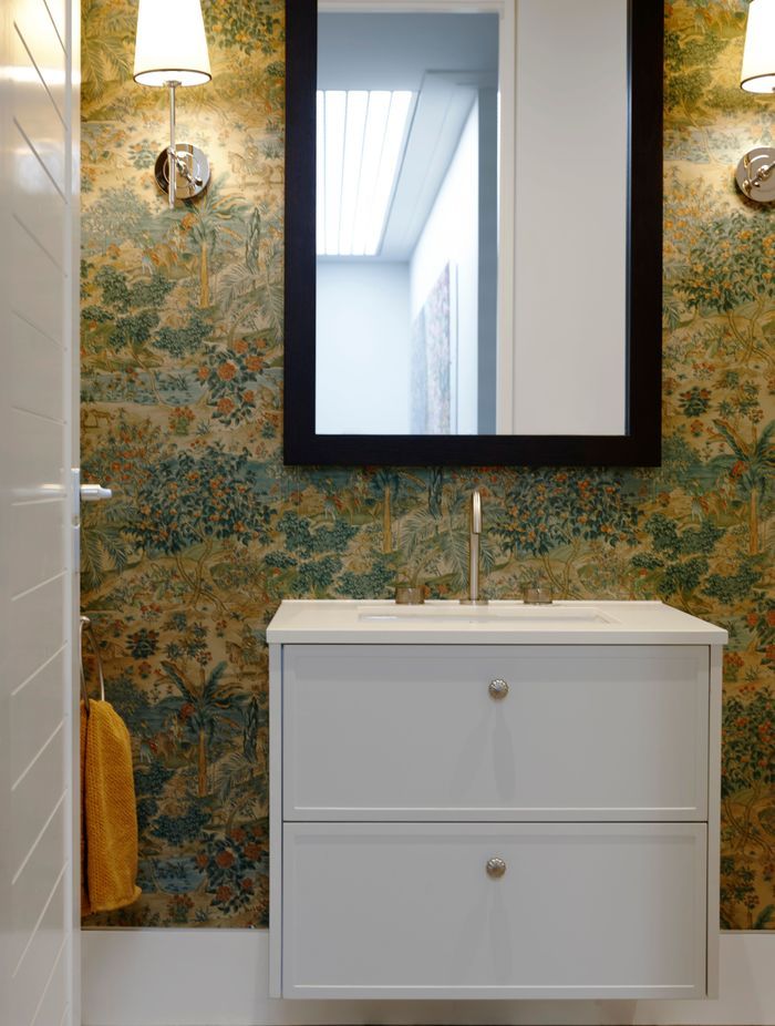 The powder room in this Remuera home features ornate wallpaper to create an elegant, stately feel.