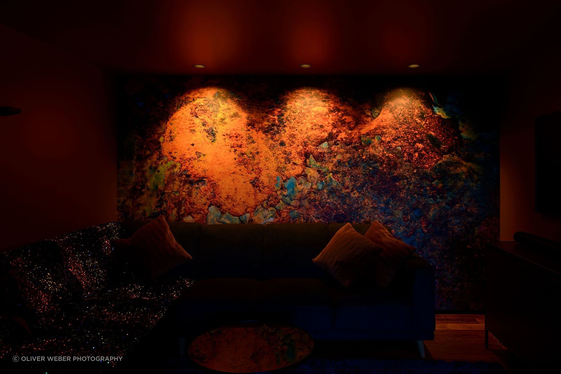Mural wall illuminated at 1,800K, enhancing the deep rich orange tones in the artwork. Product:  Switch Lighting ZELA Offset Deep Tilt  SLDL251T