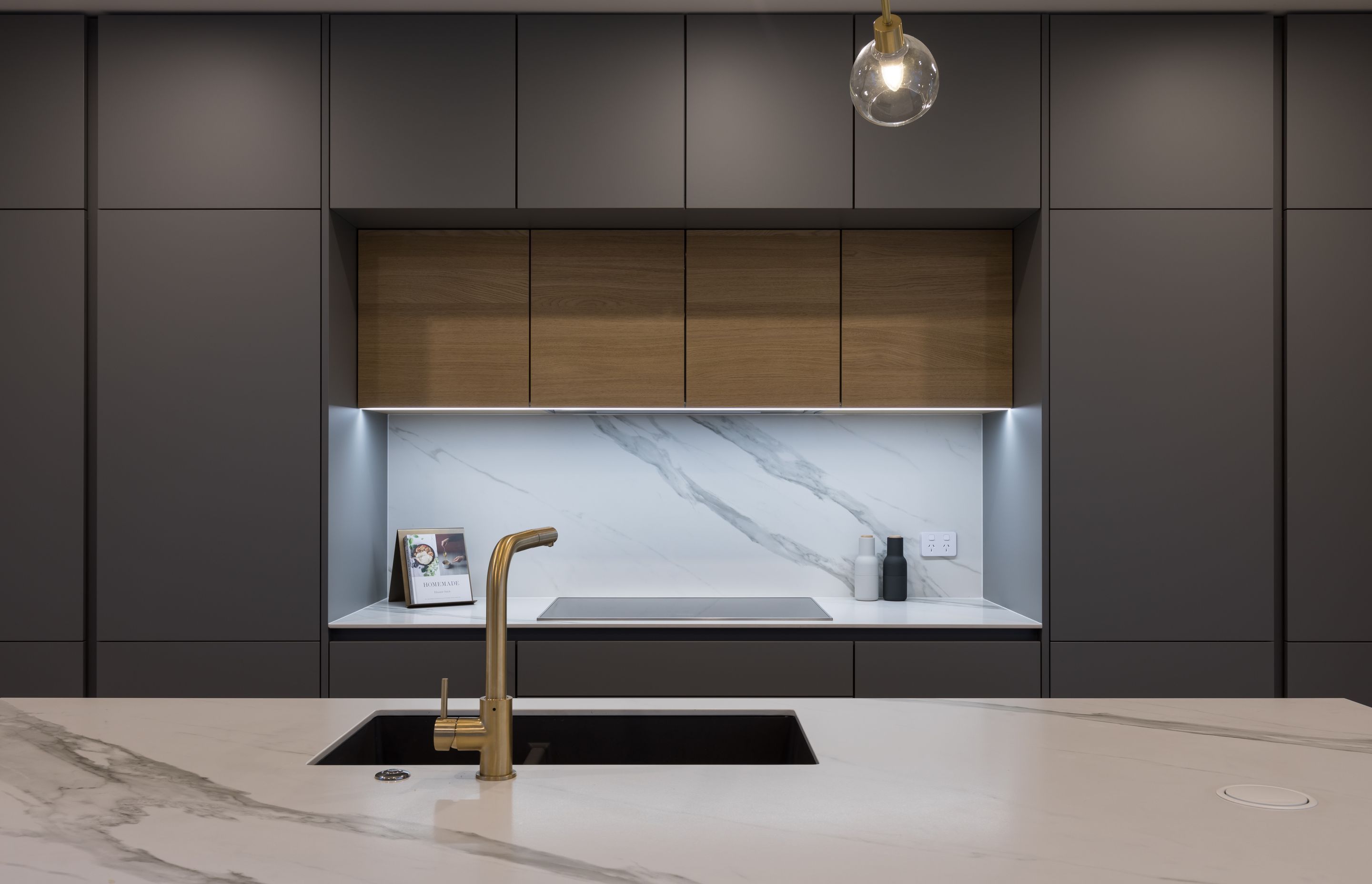 Full-height cabinetry from Poggenpohl's +Segmento range, featuring push-release hardware, imparts a streamlined feel and allows for appliances to be fully integrated.