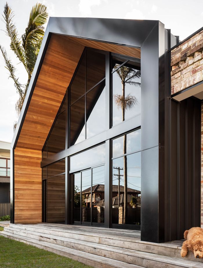 Timber warms and softens the strong lines of the facade.