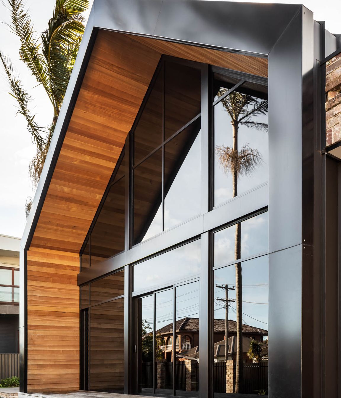 Timber warms and softens the strong lines of the facade.