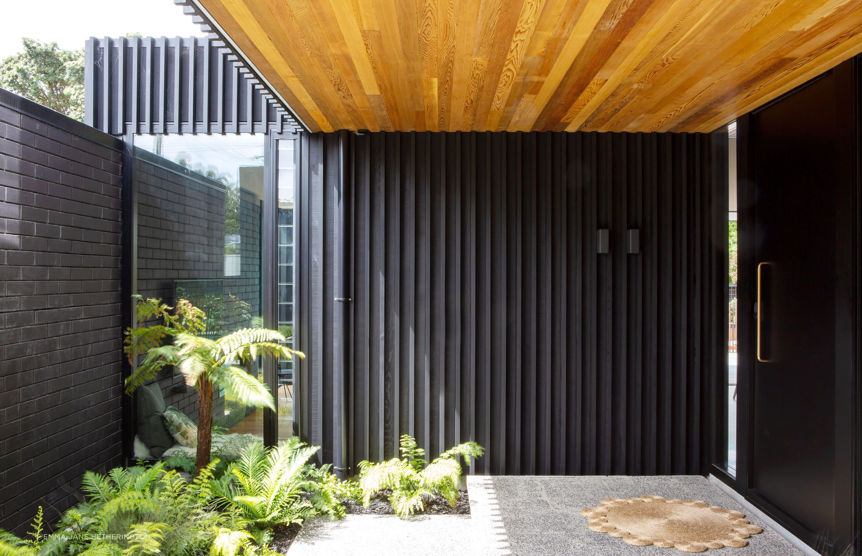 The front door, reached after walking through layers of gardens to ensure privacy. “It allows us to use that outdoor space as part of the entry,” says Tim. Dorrington Atcheson Architects worked with Strachan Group Landscape Architects on the landscaping.