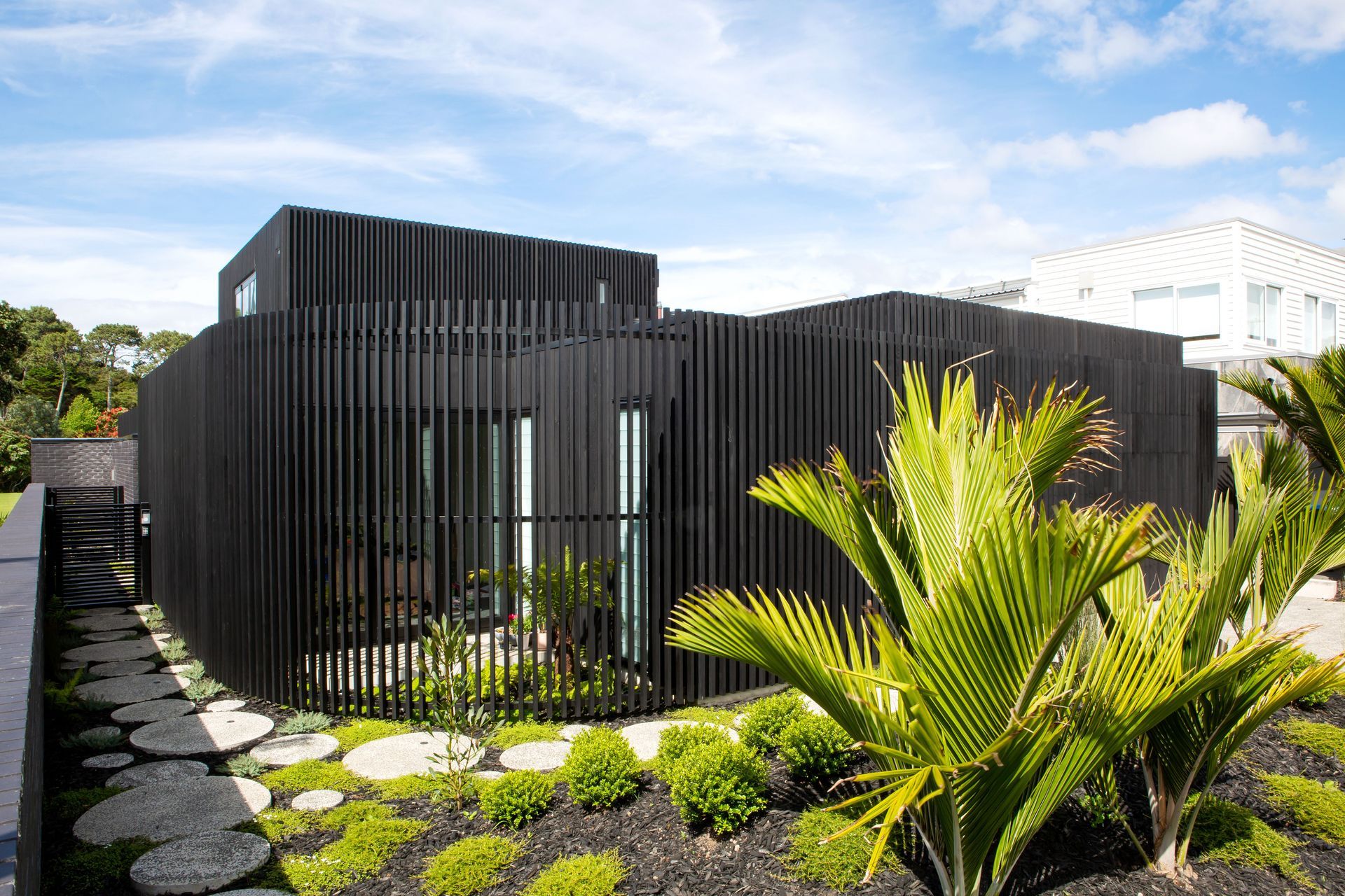 The curve that leads to the front door. Beyond the gate is the black brick boundary fence that allows the family access to the public park: the bricks were another new material, discovered by homeowner George Crawford, and are Tenerife by Austral Bricks. 