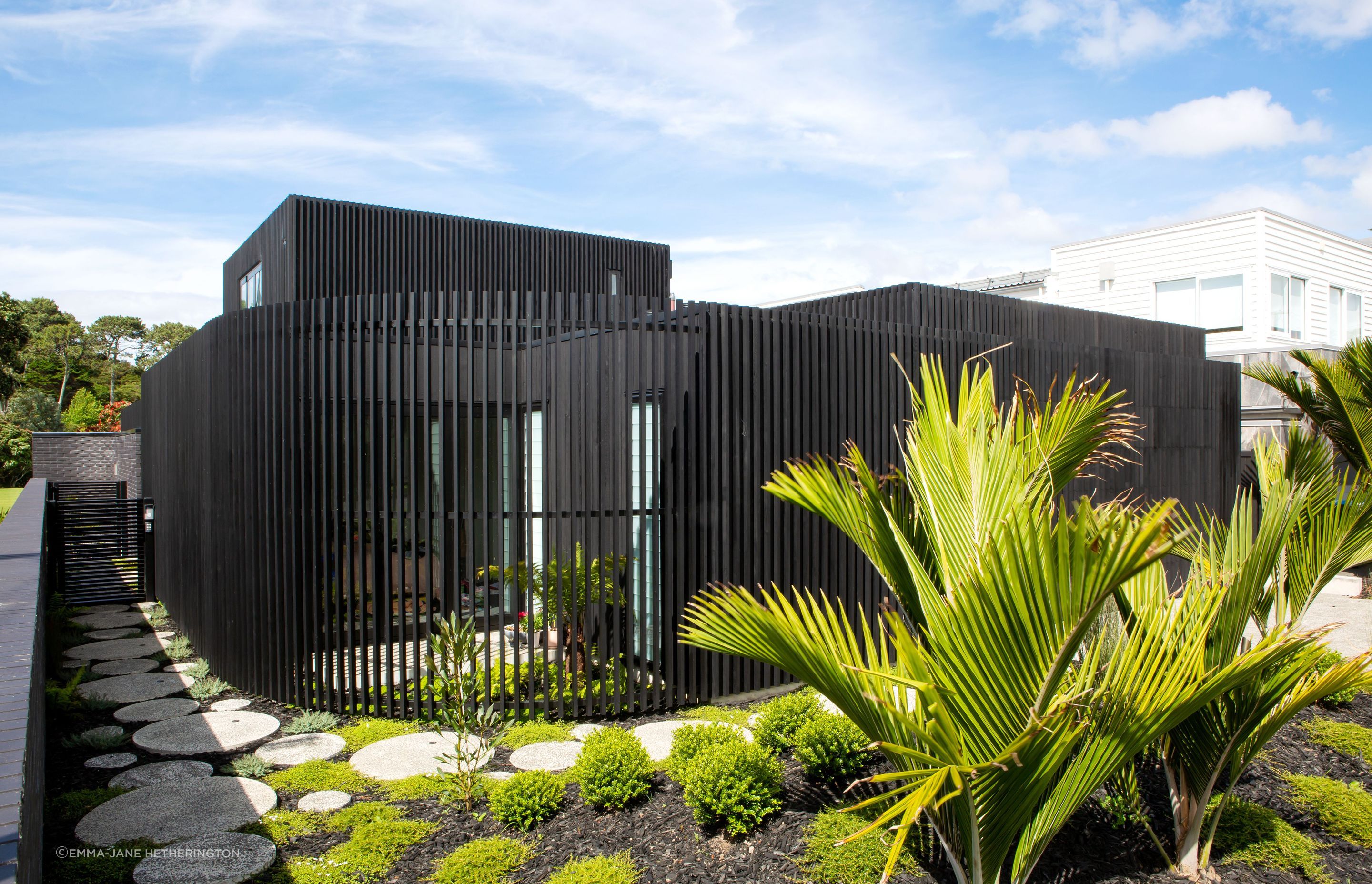 The curve that leads to the front door. Beyond the gate is the black brick boundary fence that allows the family access to the public park: the bricks were another new material, discovered by homeowner George Crawford, and are Tenerife by Austral Bricks.