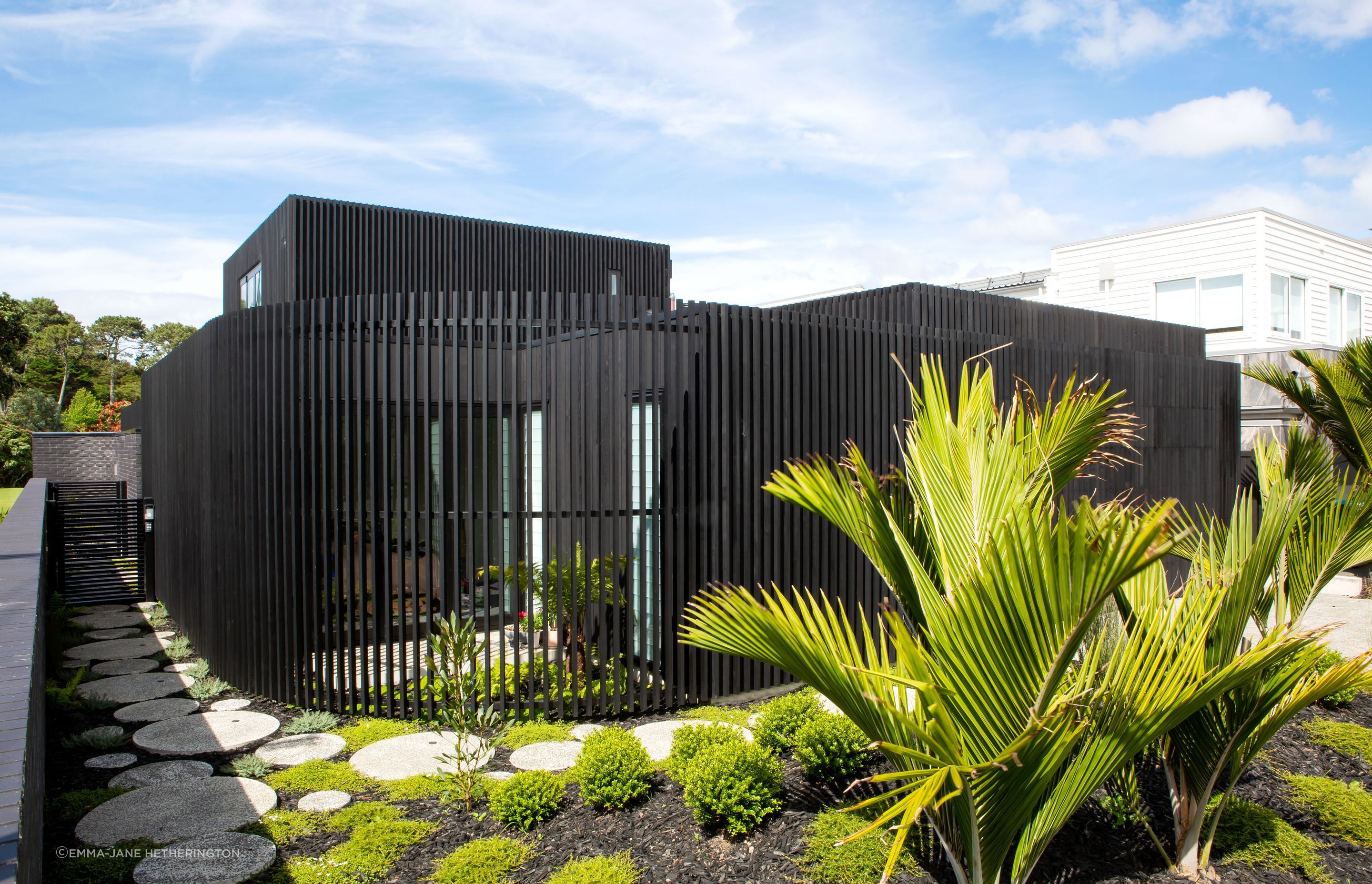 The curve that leads to the front door. Beyond the gate is the black brick boundary fence that allows the family access to the public park: the bricks were another new material, discovered by homeowner George Crawford, and are Tenerife by Austral Bricks. 