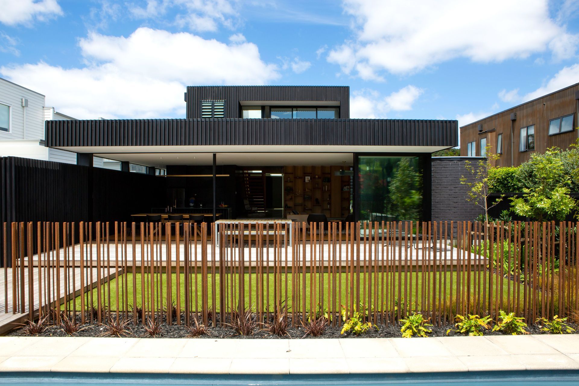 The pool fencing is custom made of corten steel rods embedded into concrete footings. “It’s a feat of engineering,” says Rina. The upstairs master suite enjoys park views.
