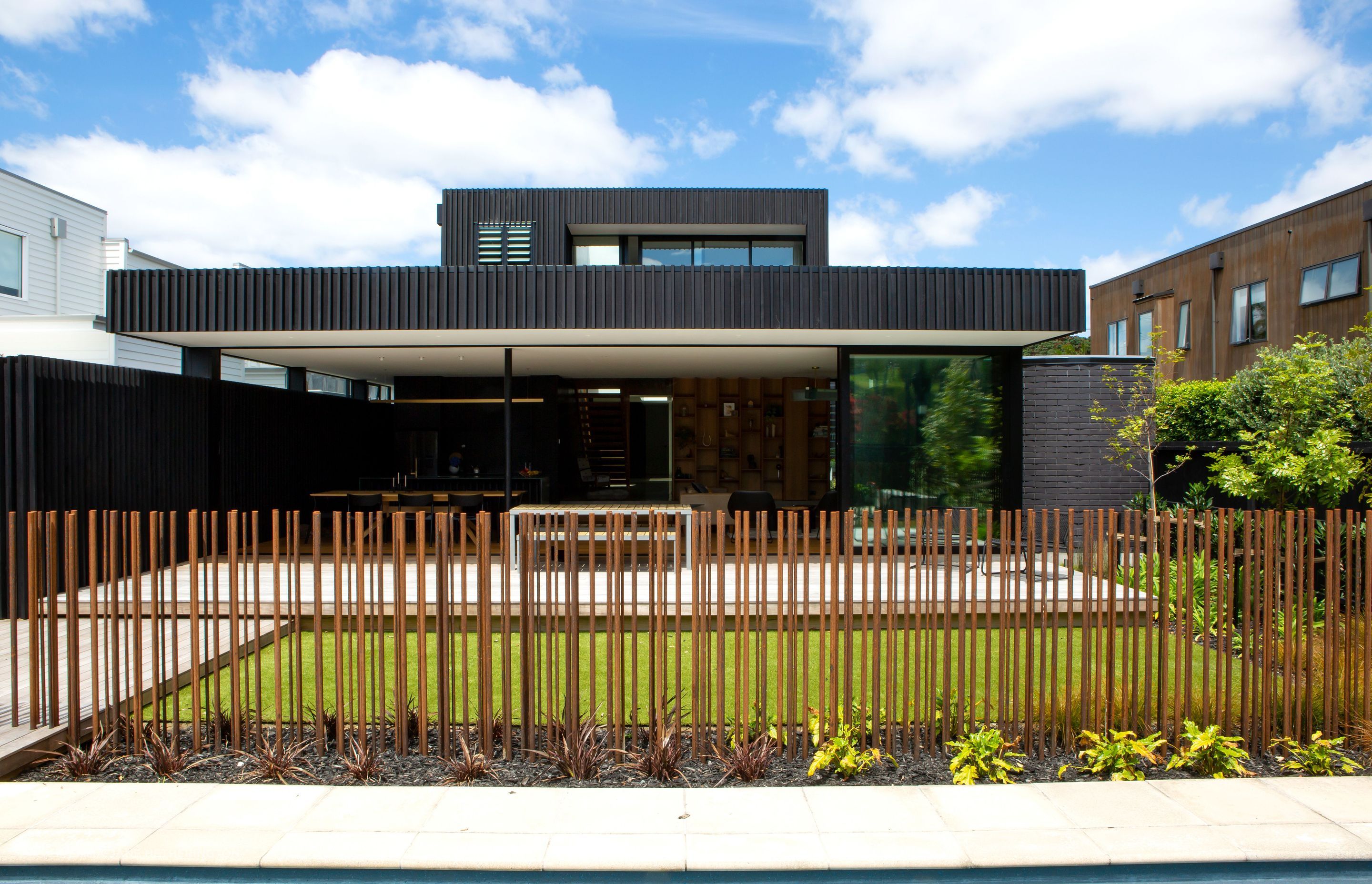 The pool fencing is custom made of corten steel rods embedded into concrete footings. “It’s a feat of engineering,” says Rina. The upstairs master suite enjoys park views.