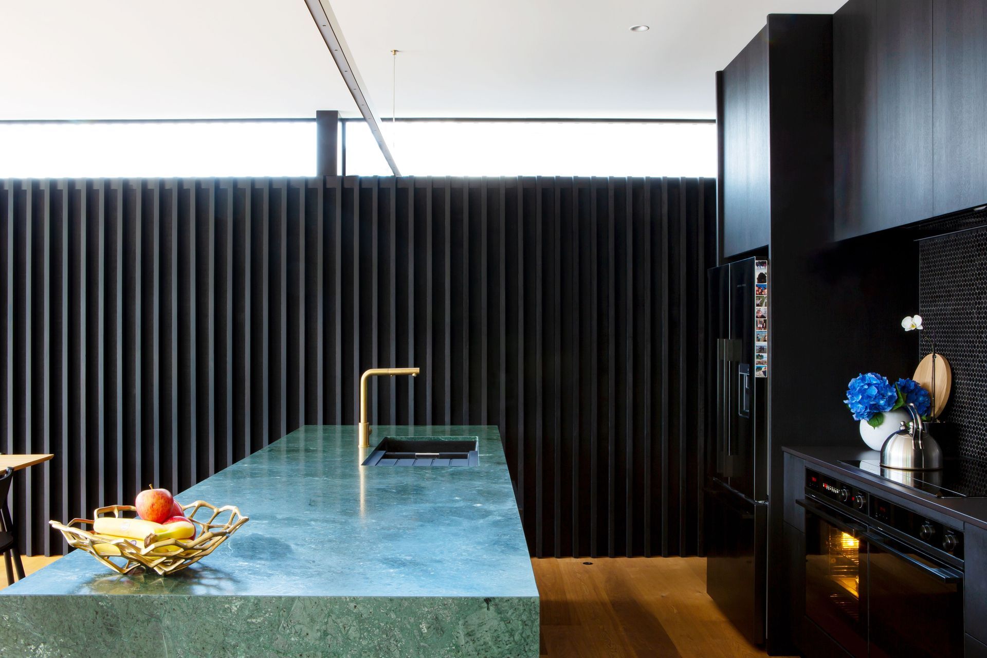 The Buddy mixer is from Plumbline and the appliances are Fisher &amp; Paykel. Dorrington Atcheson Architects project architect Sam Lennon first suggested the green marble island even though previous clients had shied away from such a bold statement.
