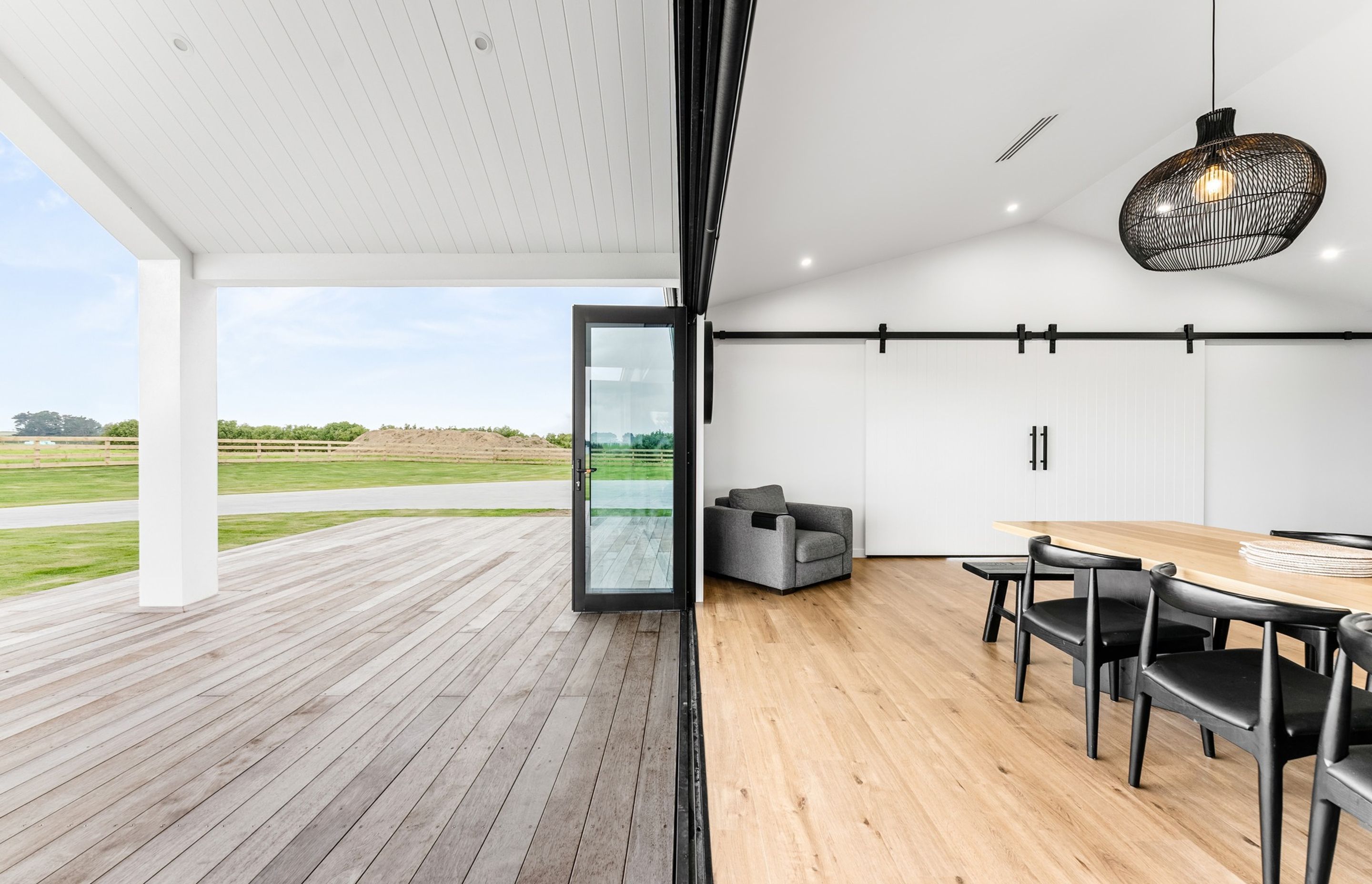 Bi-fold doors let the outside in, while barn doors close off the second living.