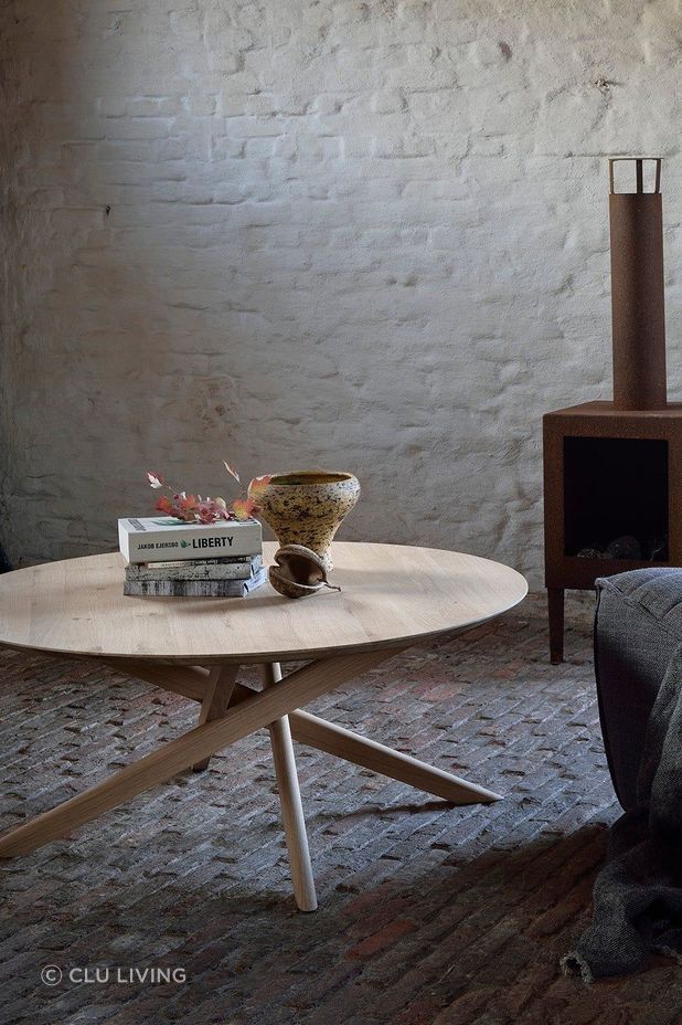 A smooth, round coffee table fits easily in rooms of different styles.