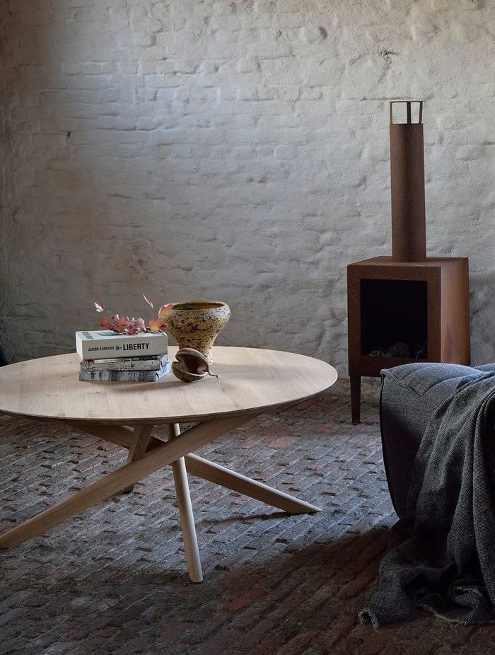 A smooth, round coffee table fits easily in rooms of different styles.