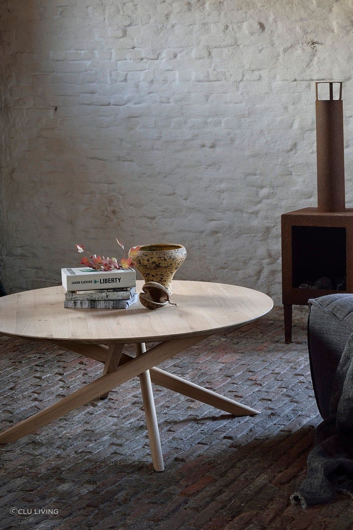 A smooth, round coffee table fits easily in rooms of different styles.