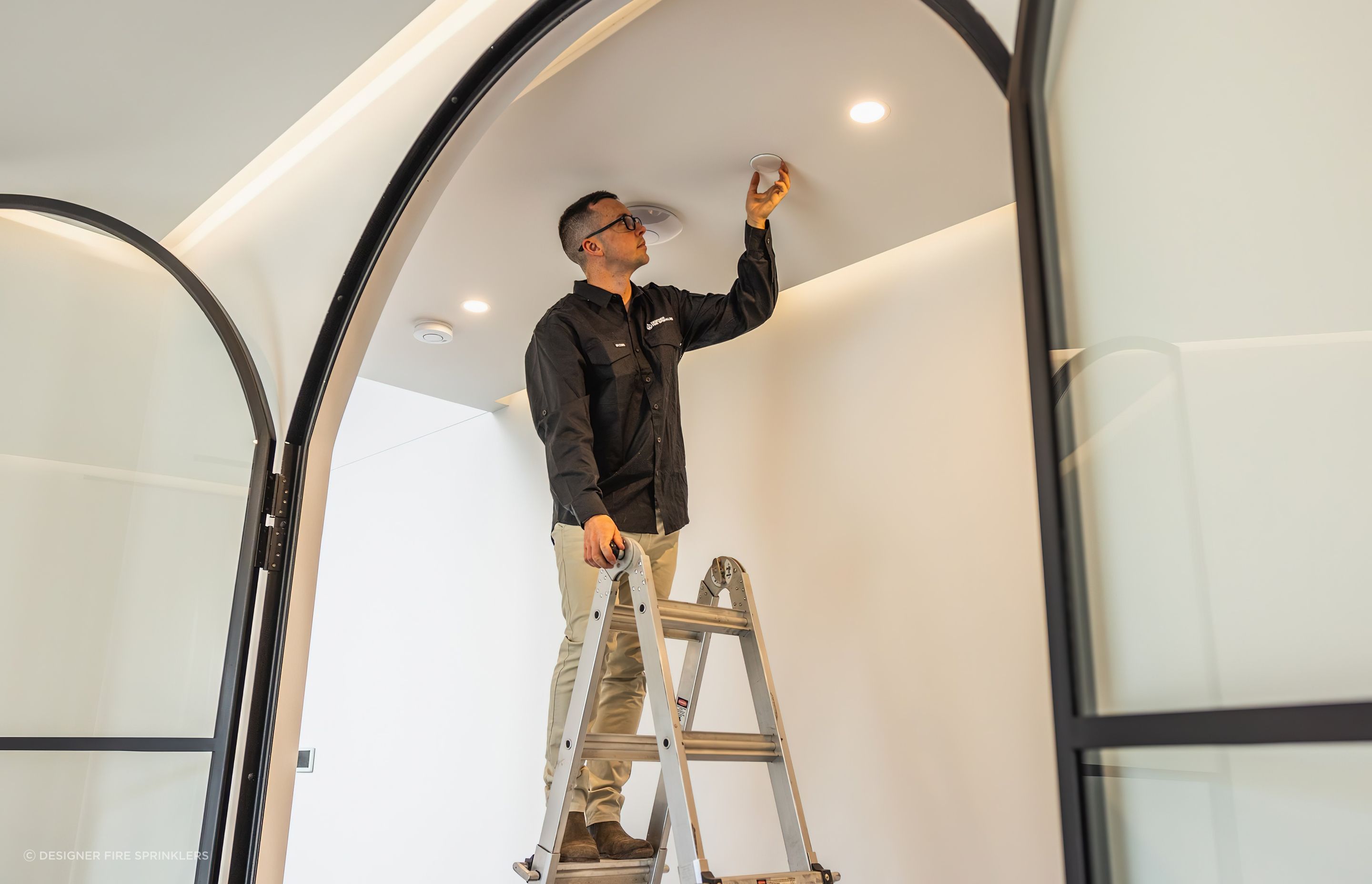 Our Founder and sprinkler fitter, Raphael Corbett installing sprinkler covers.