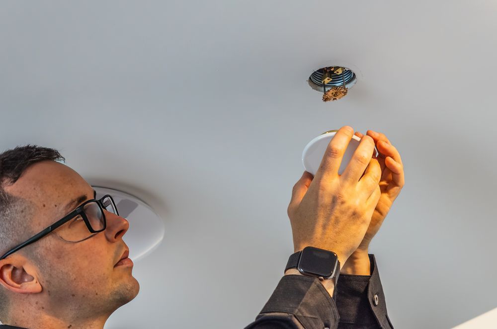 Designer Fire Sprinklers’ co-founder, Raphael Corbett installing a sprinkler head.