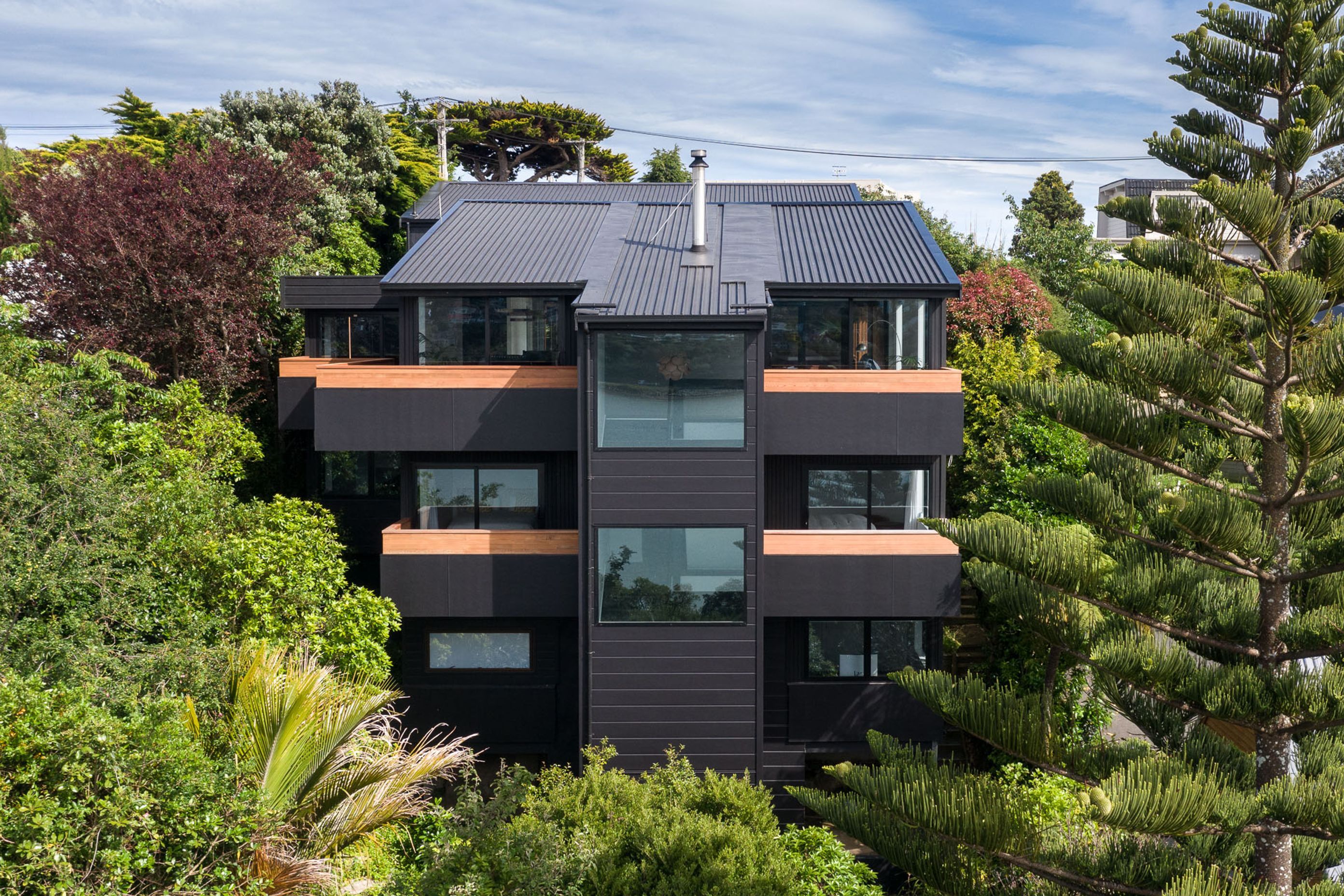 The house’s protective facade, designed to enhance views from the interior out across the harbour.