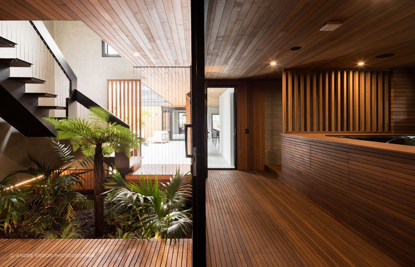 The stairwell and neighbouring spa pool/outdoor shower, post-renovation. The point of entry has been revitalised with a vibrant garden and a re-defined navigation path.