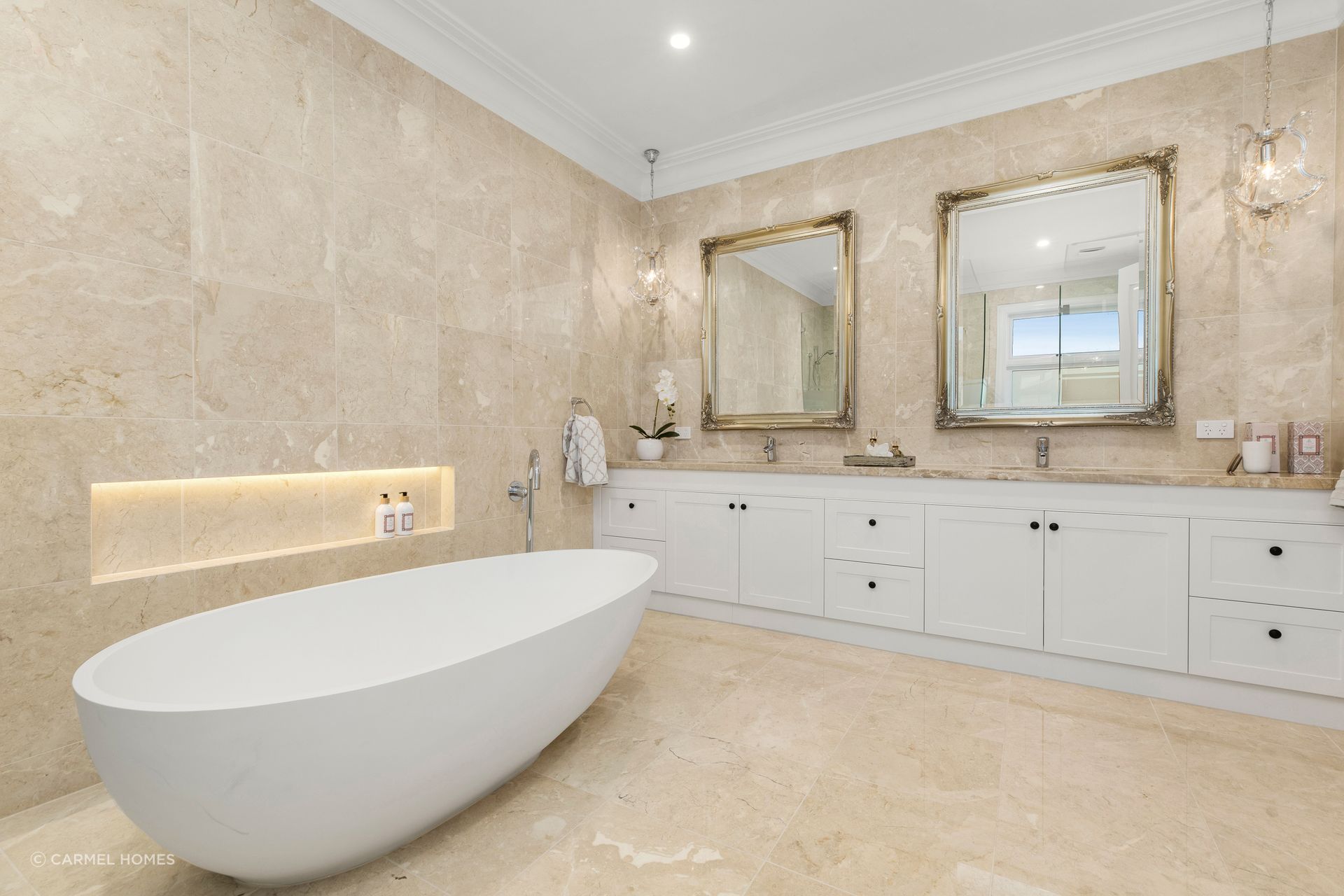 The bathroom of this French Provincial inspire home features two incredibly opulent wall mirrors