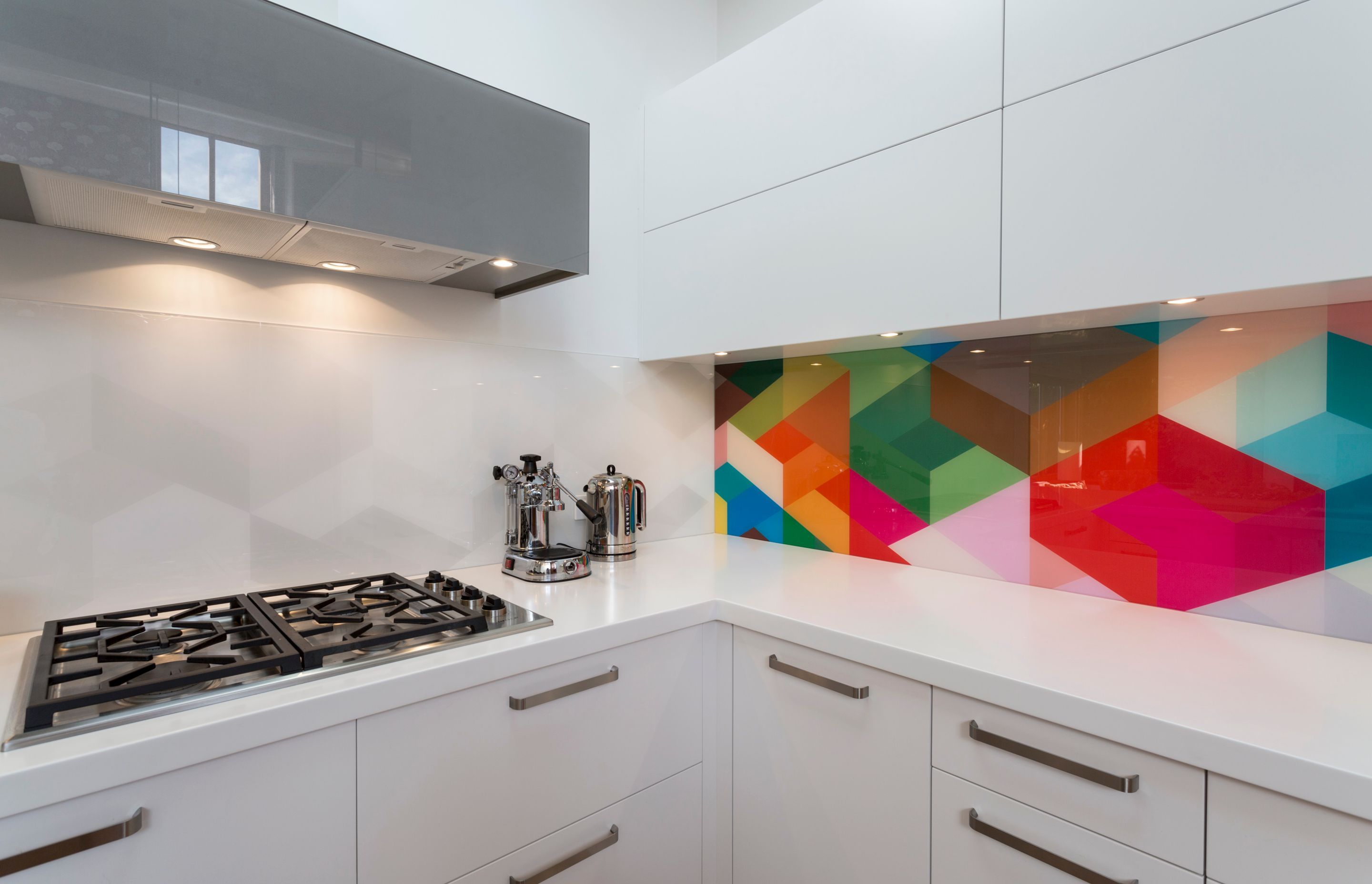 This kitchen designed by Toni Roberts from Kitchen Architecture demonstrates how you can create a piece of art that has high impact. Note the bright geometric pattern is replicated in grey tones on the adjacent wall and the overall effect is still as stunning today as it was in 2015 when it was installed.