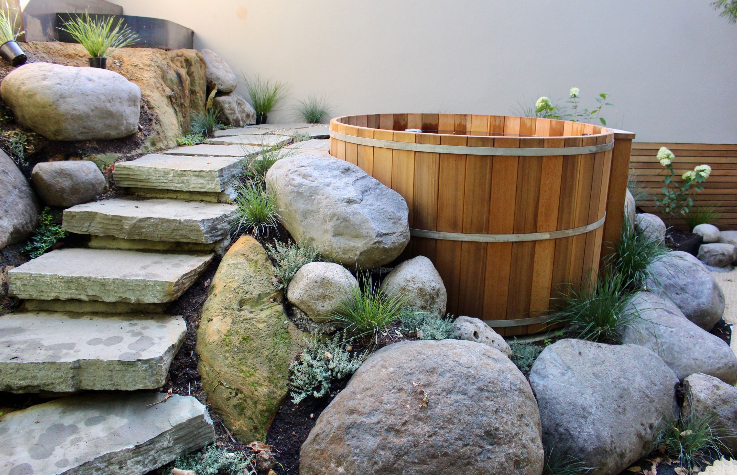 Incorporate a cedar hot tub into your backyard landscaping scheme to create a true lifestyle experience.