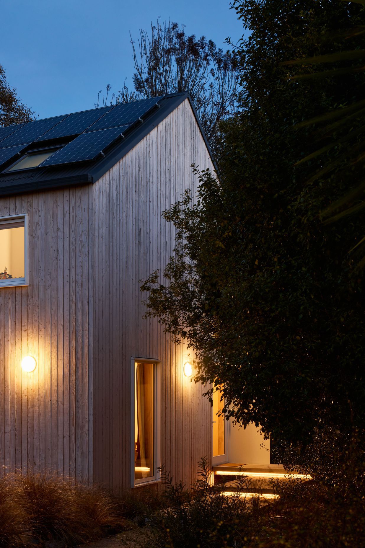 The home maintains an inviting aura even as night falls.