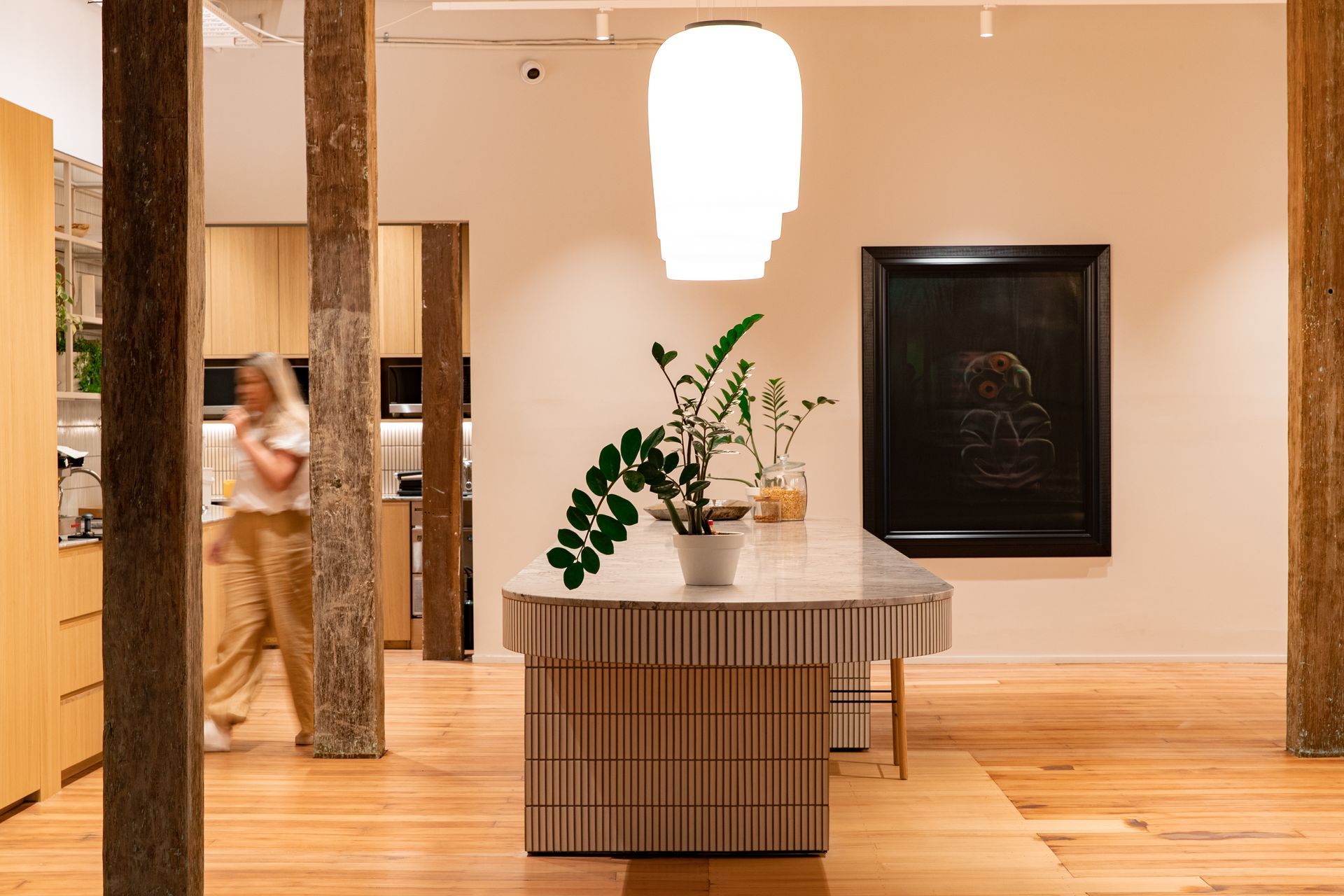 The kitchen, designed around the jarrah beams and with generous space for team collaboration at the kitchen island. | Photographers: Oliver Compton & Millie Cossou