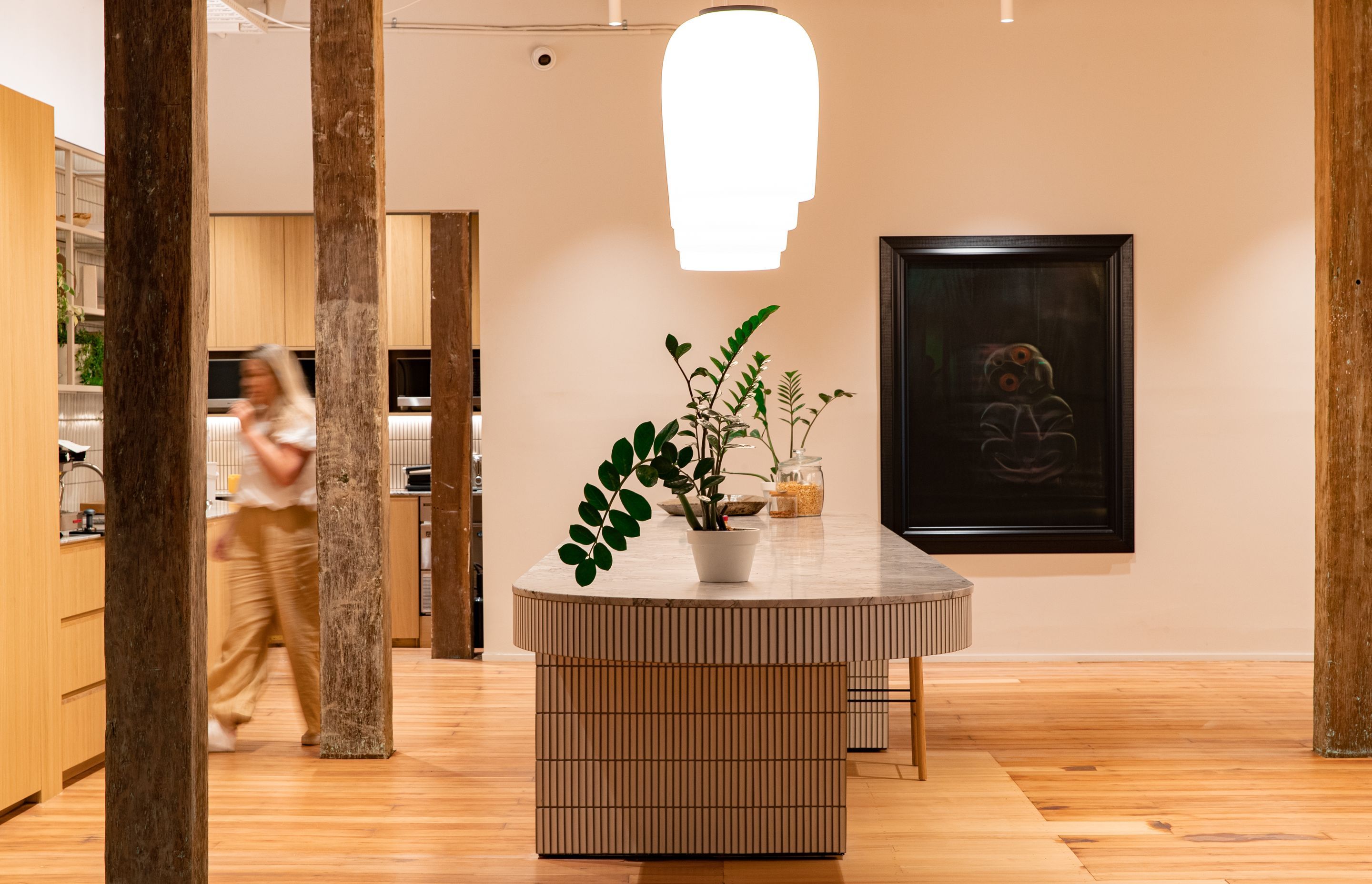 The kitchen, designed around the jarrah beams and with generous space for team collaboration at the kitchen island. | Photographers: Oliver Compton &amp; Millie Cossou