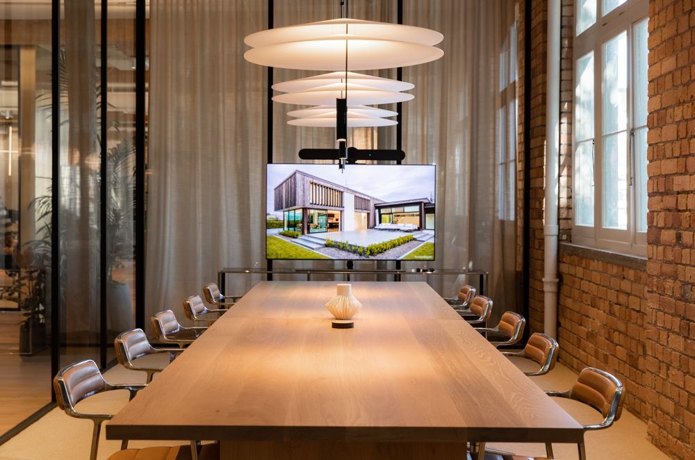 The boardroom, separated from the adjacent lounge by glass partitioning and a full drop sheer curtain. | Photographers: Oliver Compton & Millie Cossou