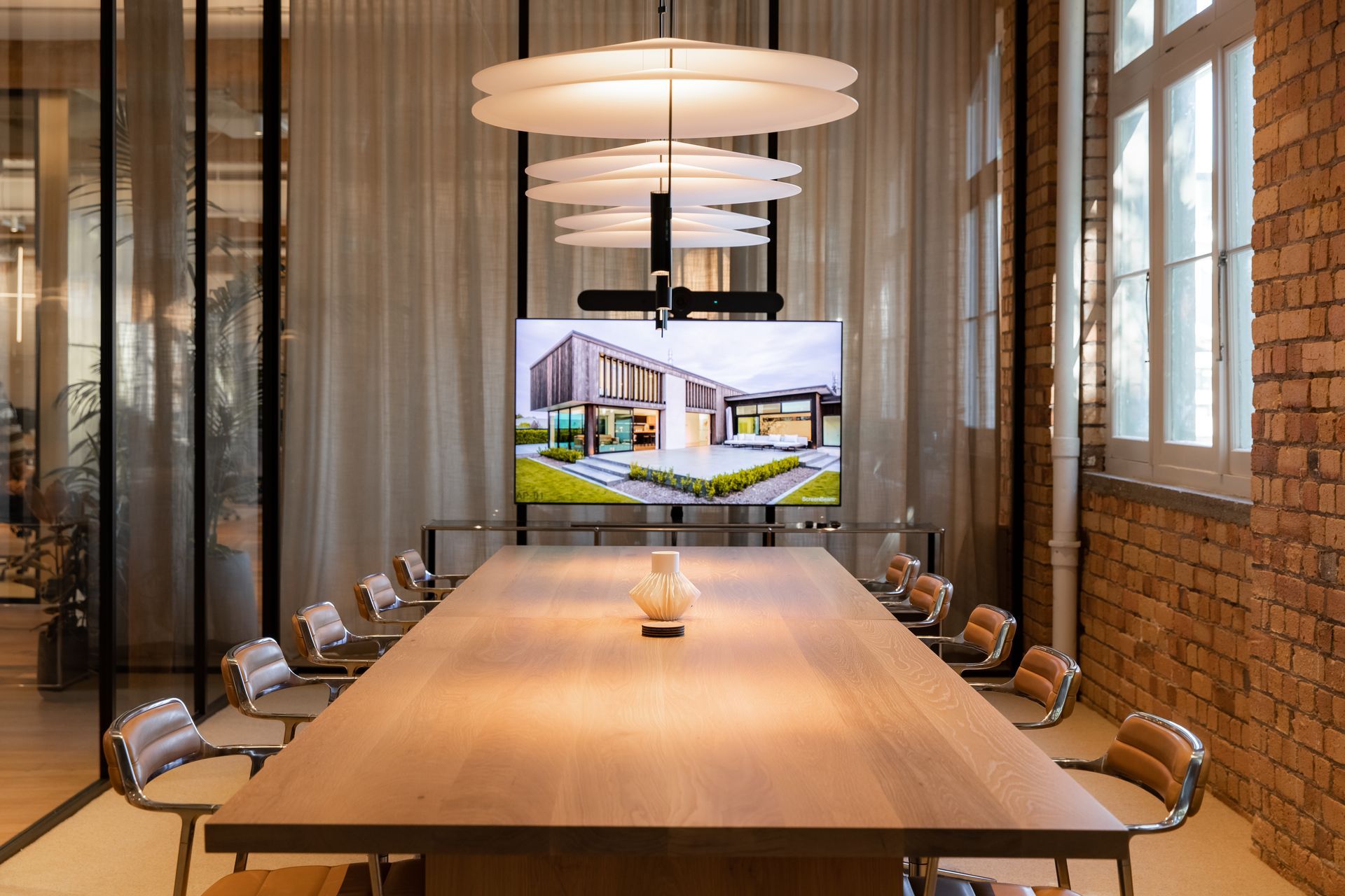 The boardroom, separated from the adjacent lounge by glass partitioning and a full drop sheer curtain. | Photographers: Oliver Compton & Millie Cossou